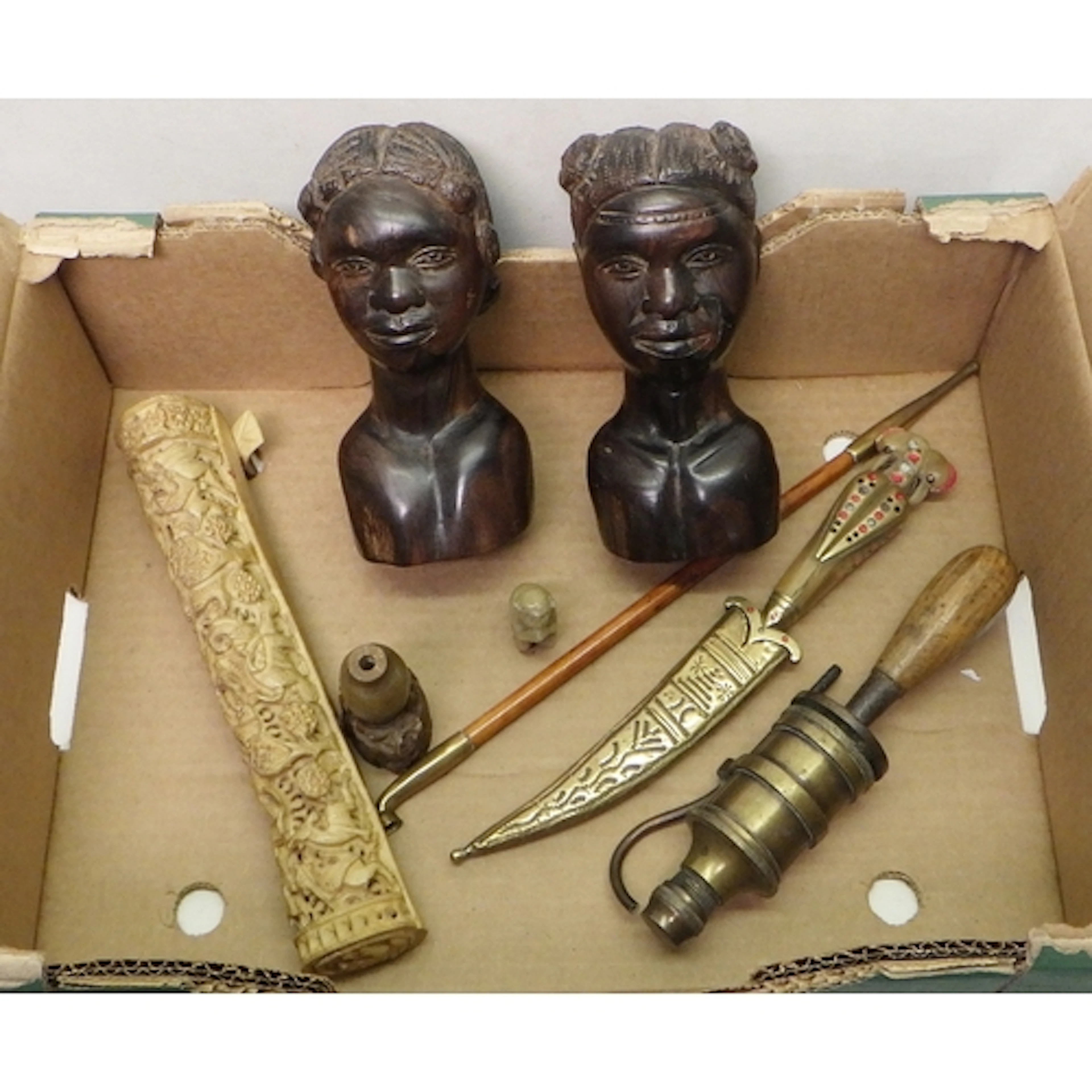 Two African carved hardwood busts; a stylized forest frieze ...