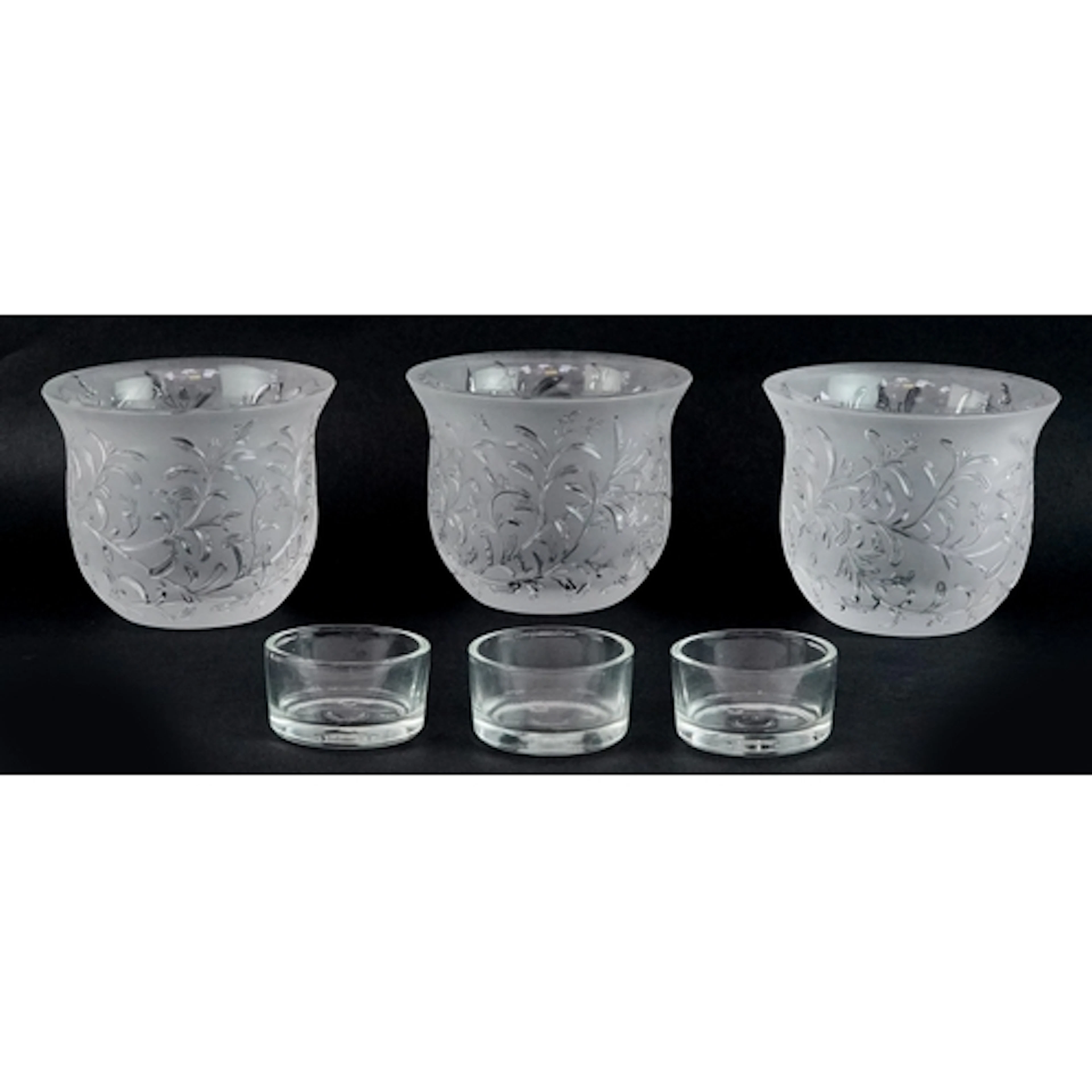 Three Lalique frosted glass tealight holders in the Rosemary...