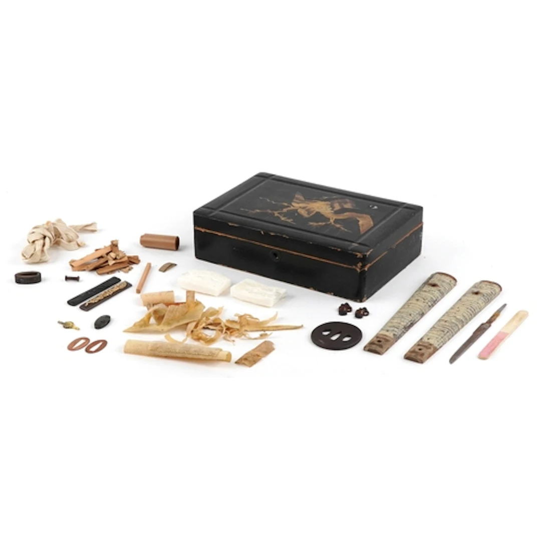 Japanese lacquered box housing a collection of sword fitting...