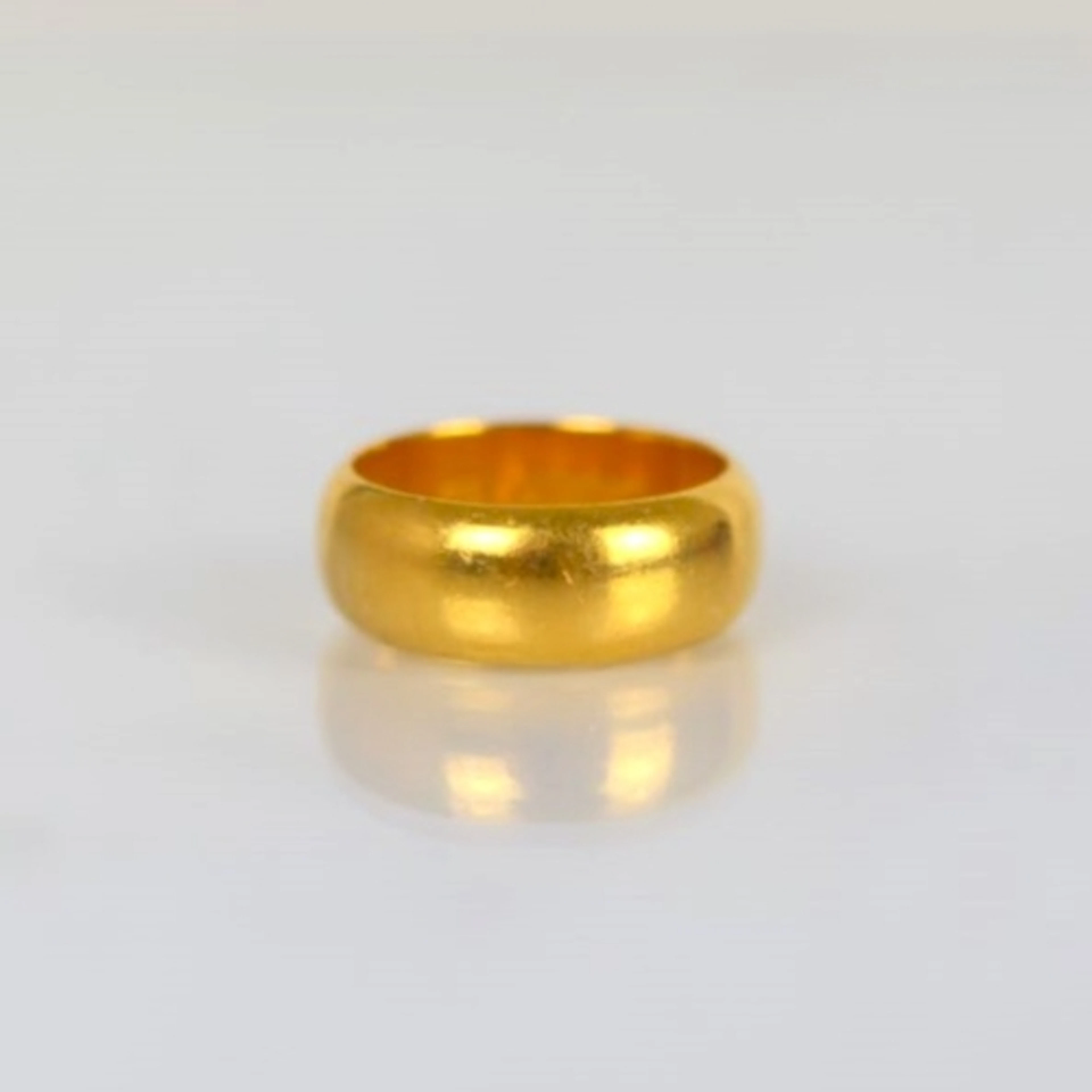 A mid 20th century 22ct yellow gold wedding band, stamped 'W...