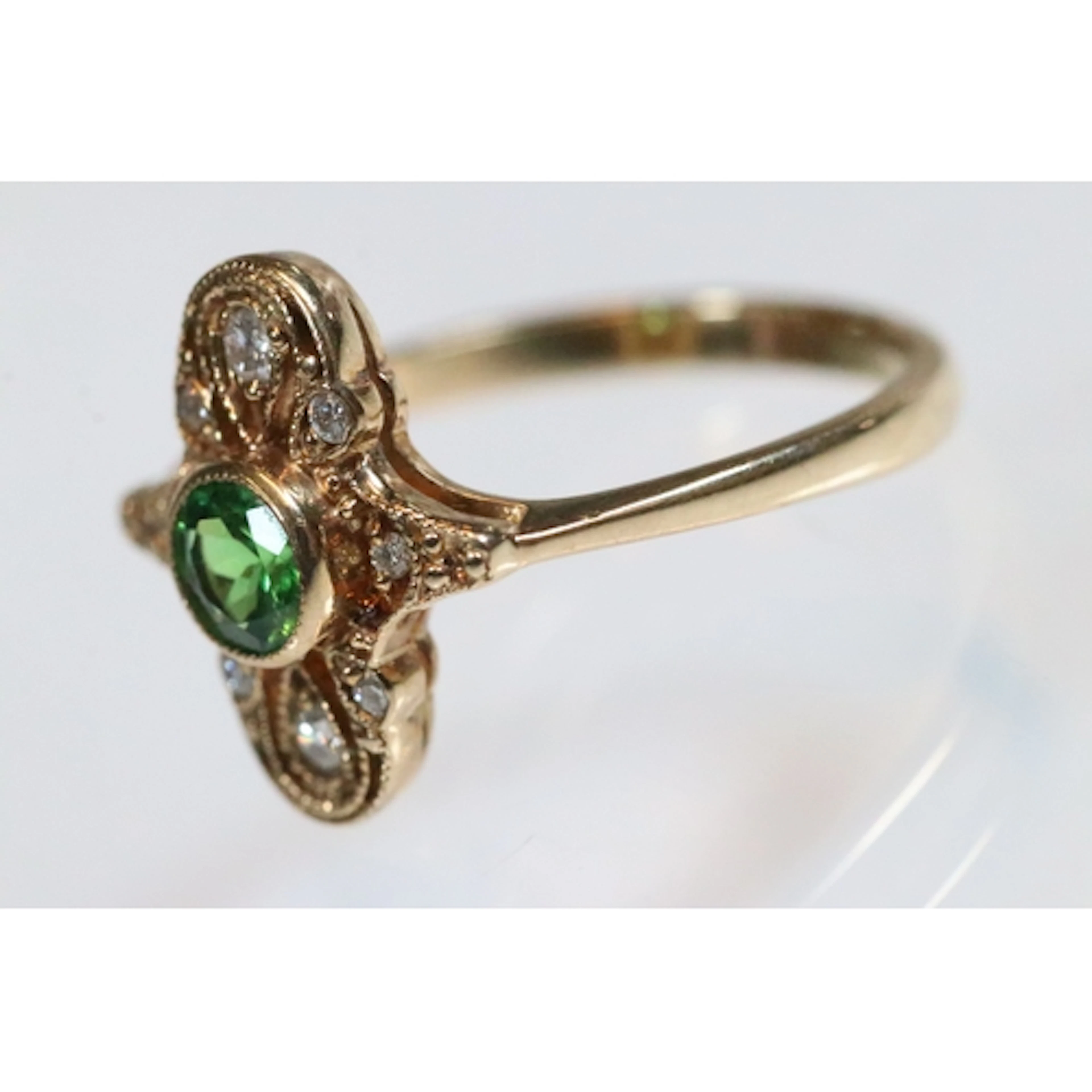 9ct gold tsavorite garnet and diamond panel ring. The ring b...
