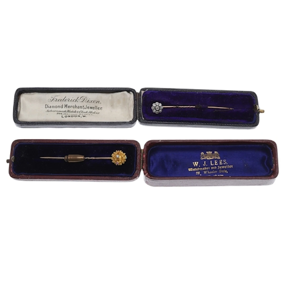 TWO GOLD AND GEM SET STICK PINS. comprising a diamond stick ...