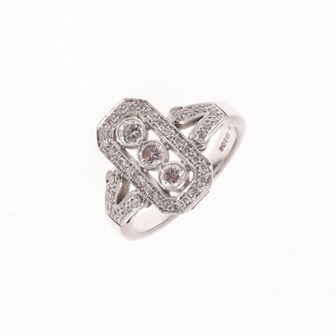 A DIAMOND CLUSTER RING. centred with three collet set circul...
