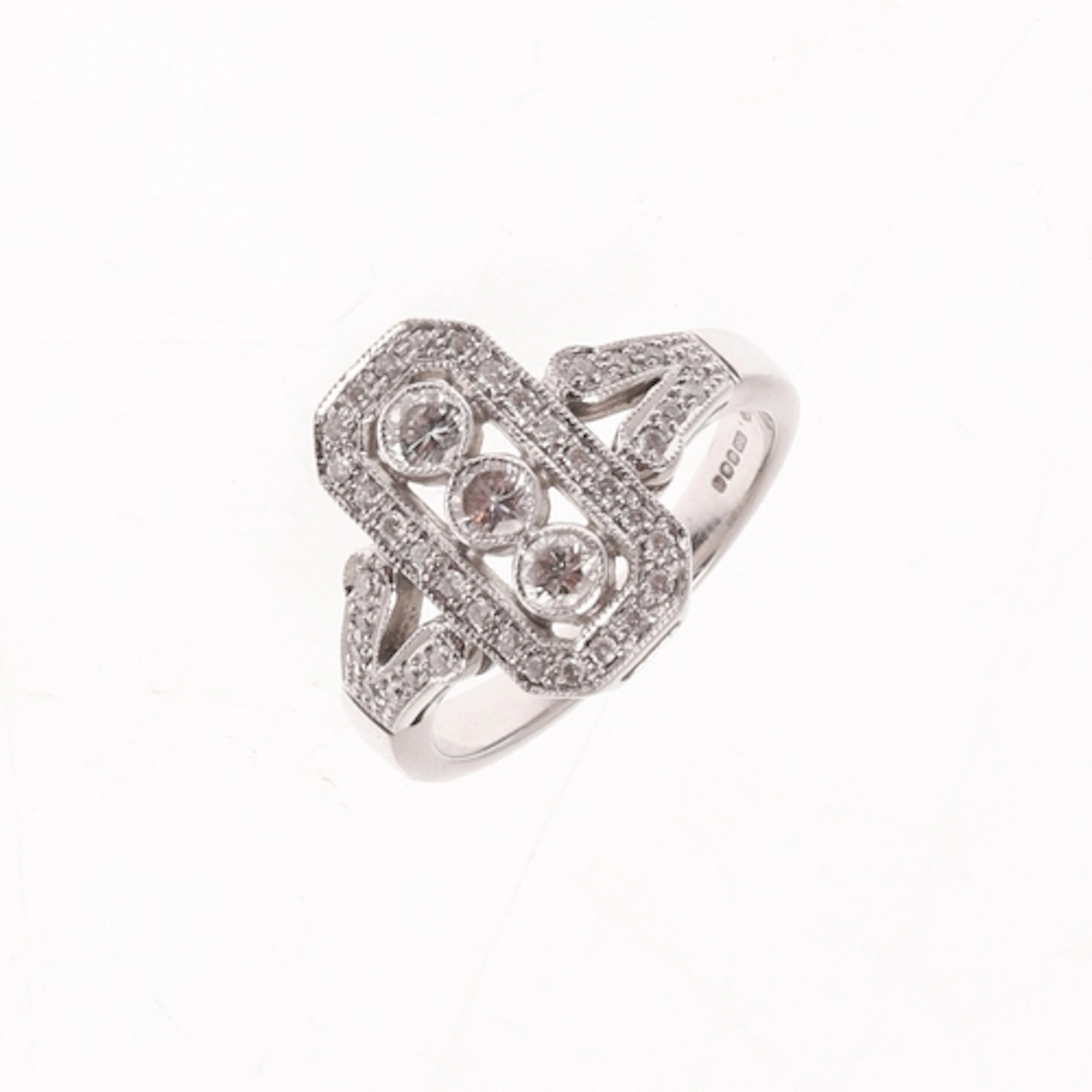 A DIAMOND CLUSTER RING. centred with three collet set circul...