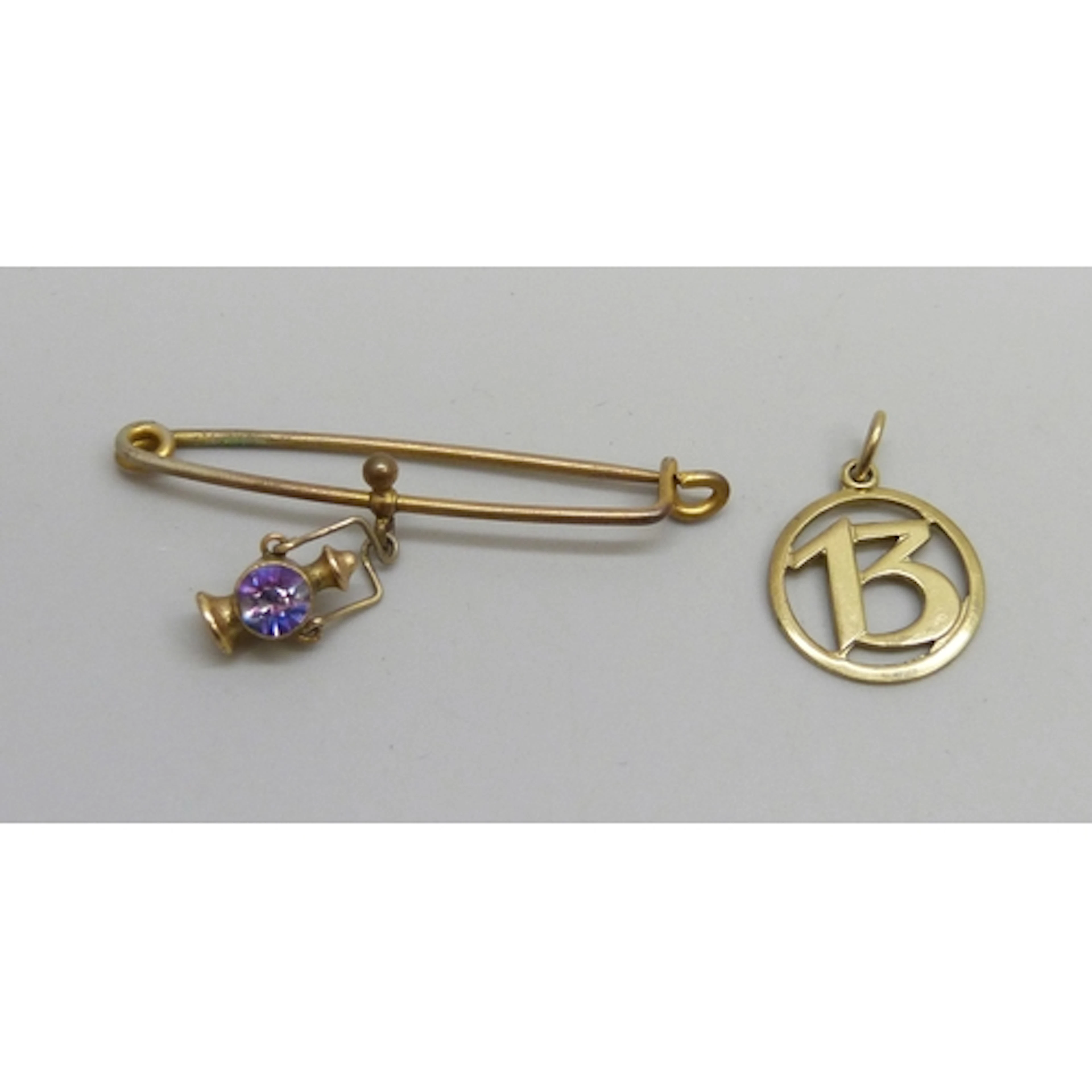 A yellow metal 13 pendant marked 333 for 8ct gold, 0.8g, and...