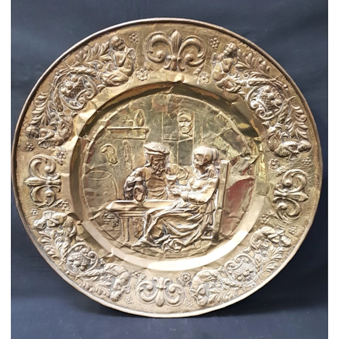 LARGE RELIEF DECORATED BRASS WALL CHARGER the circular charg...