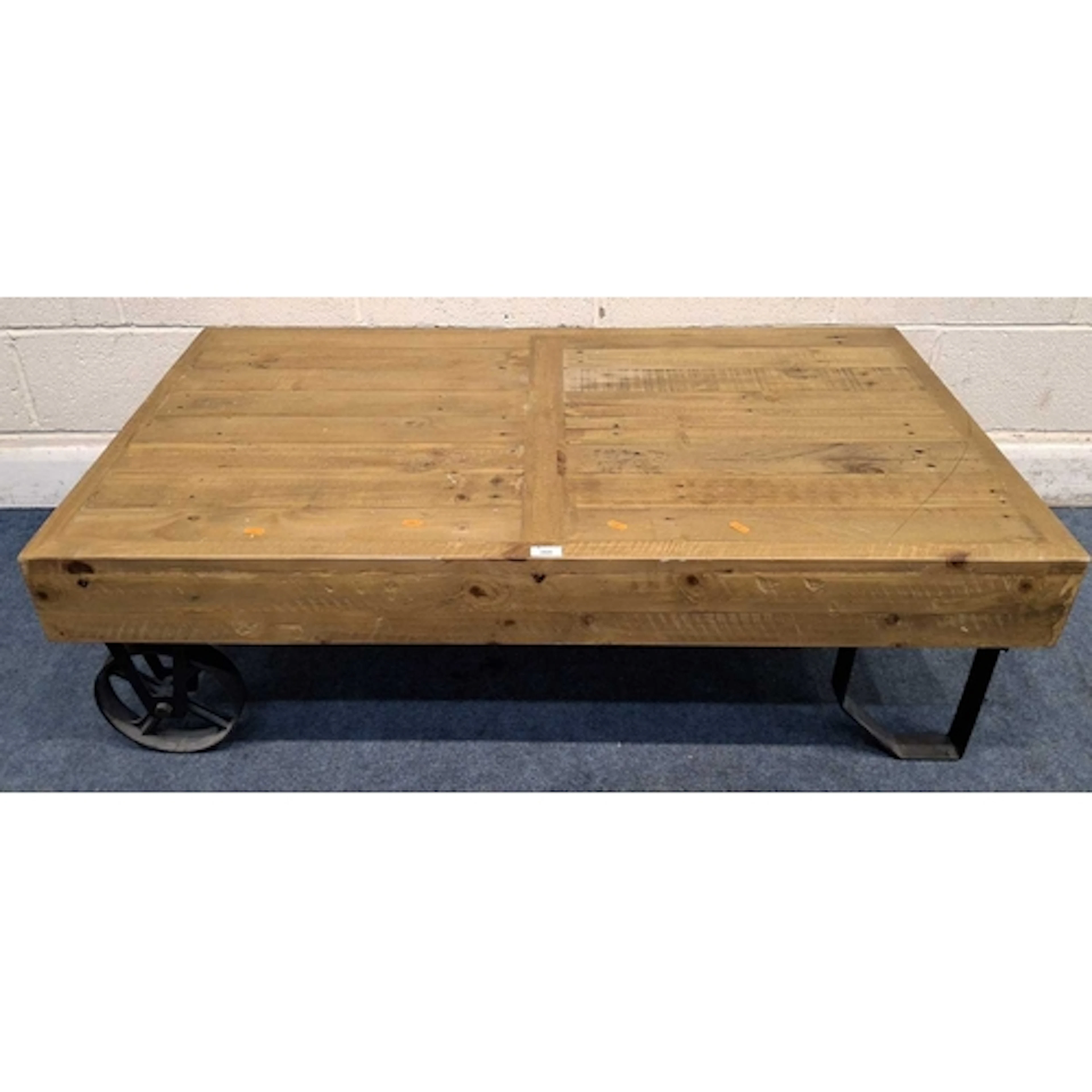 AN INDUSTRIAL-STYLE HARDWOOD COFFEE TABLE, with cast iron le...