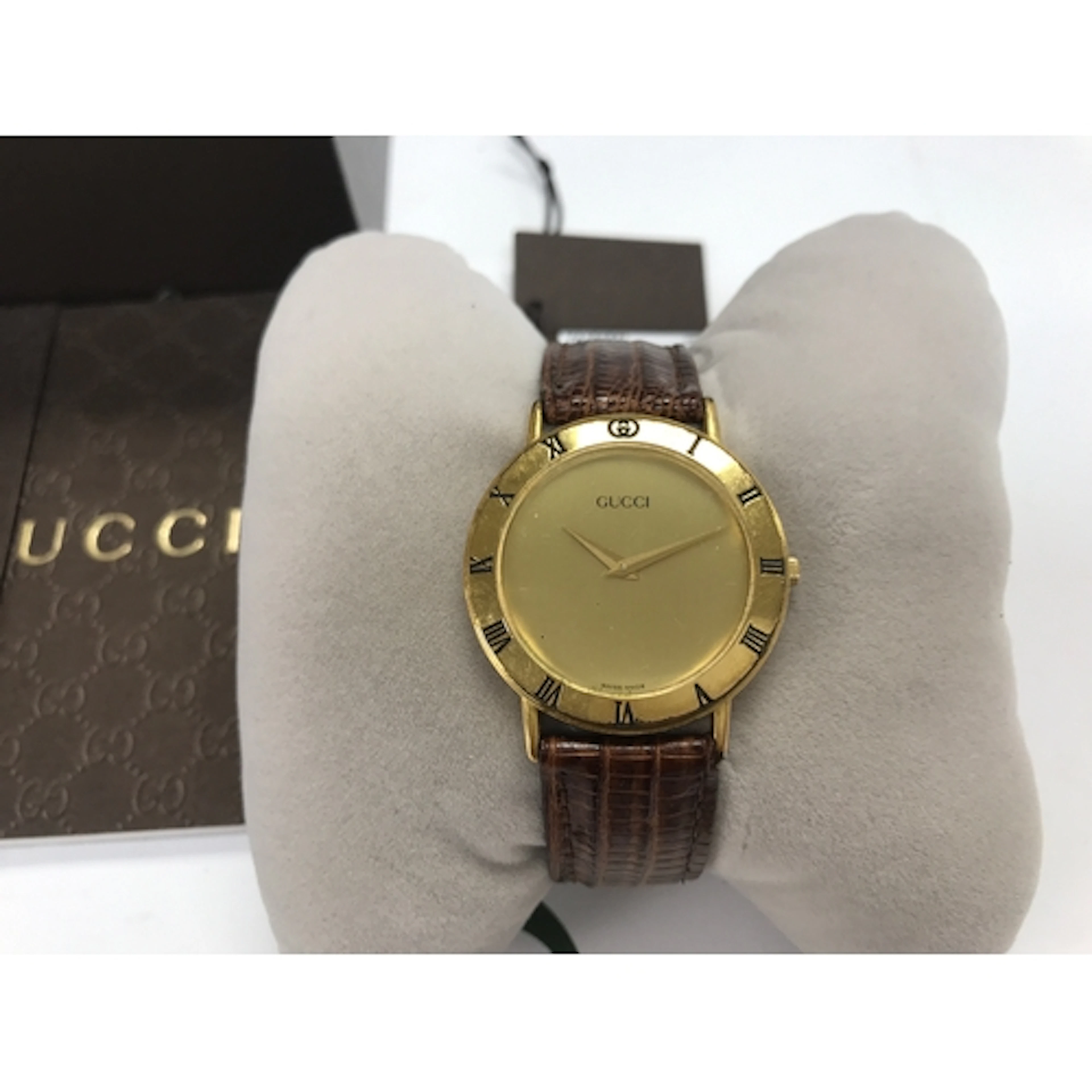 vintage Gucci quartz wristwatch featuring a round gold-tone ...