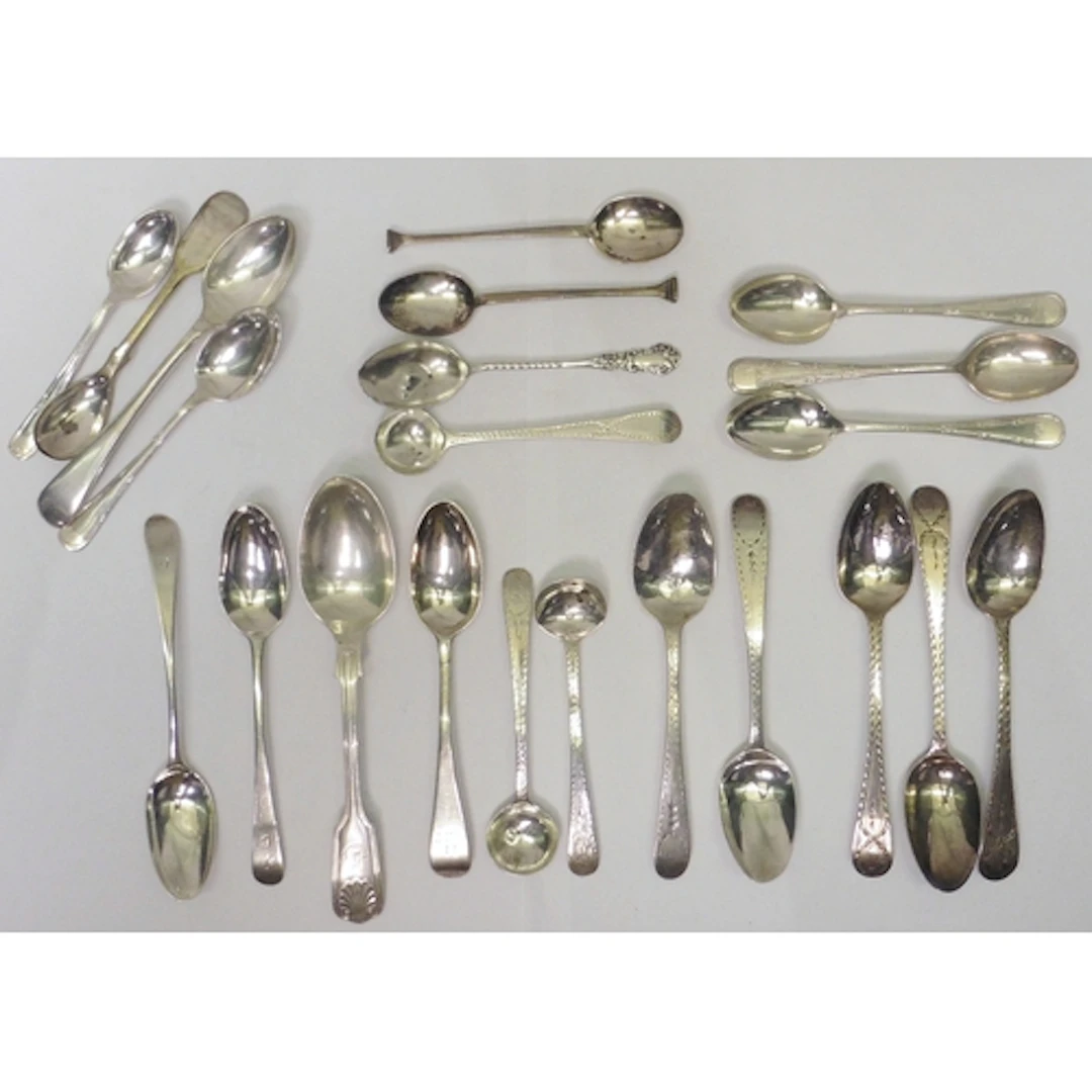 A pair of collection of teaspoons and condiment spoons, most...