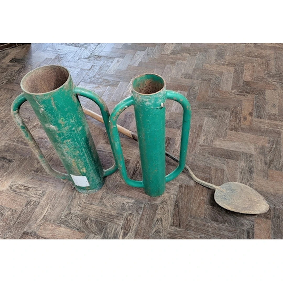 Two green heavy duty fence post drivers together with a vint...