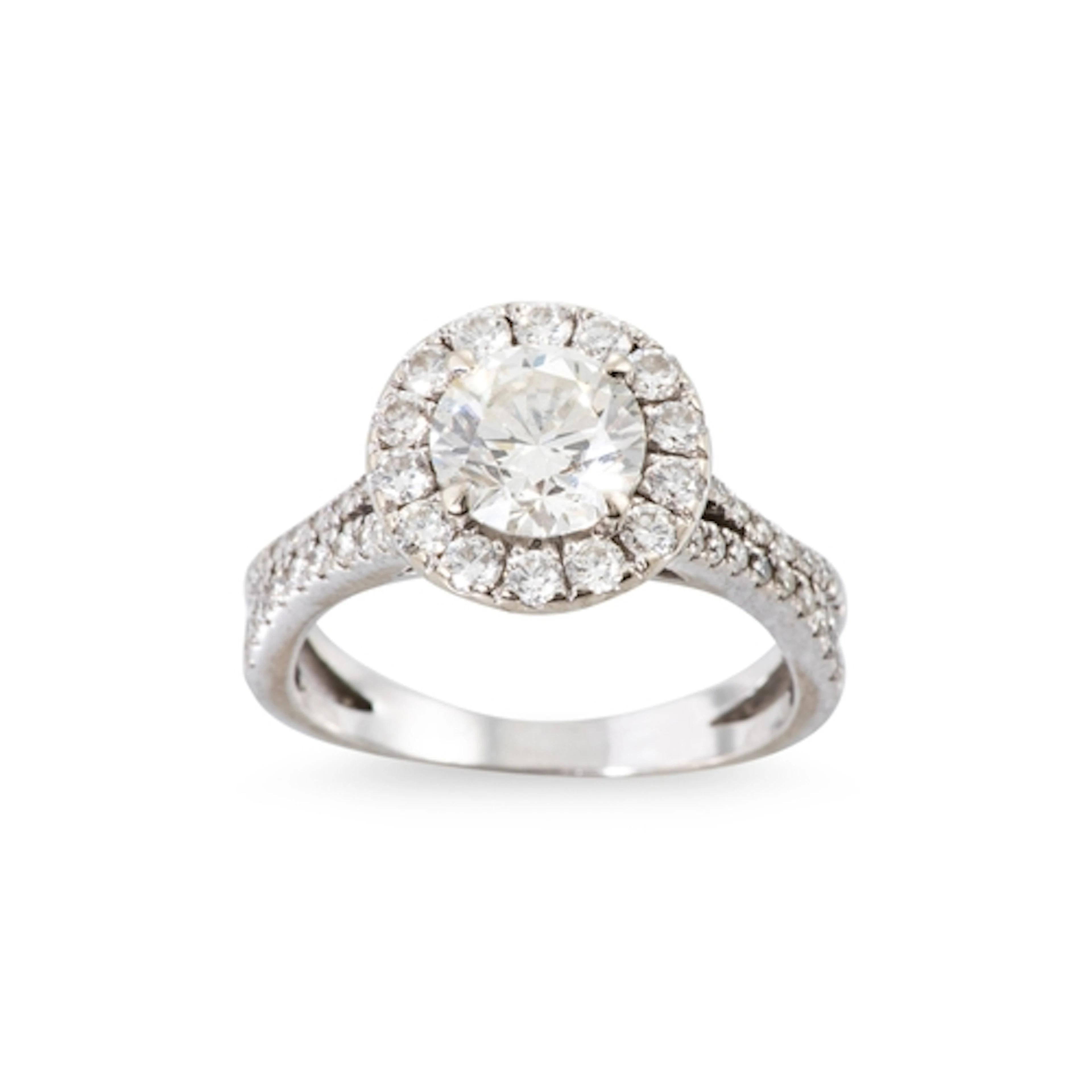 A DIAMOND SOLITAIRE RING, the brilliant cut diamond to halo ...