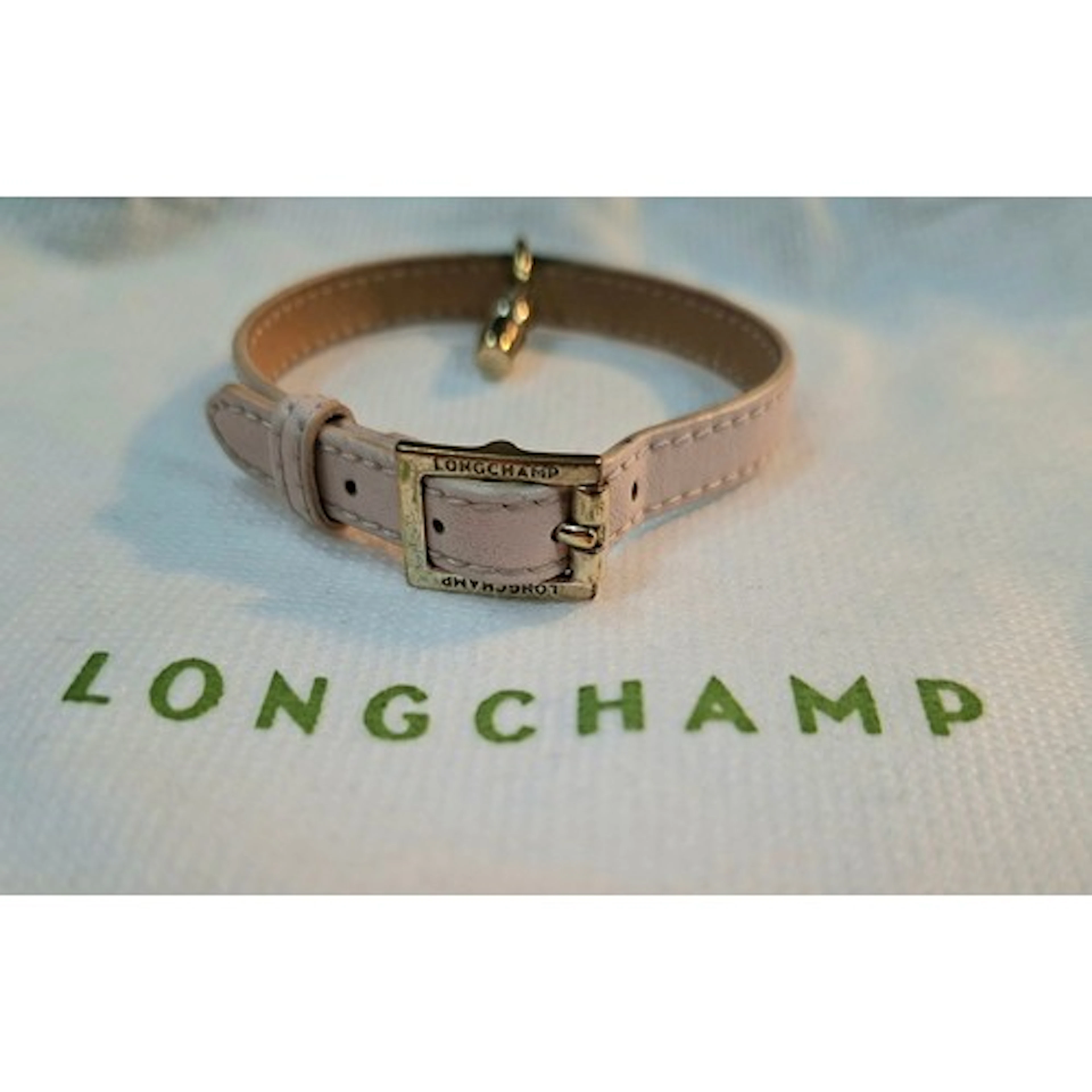 Longchamp- A light pink leather strap bracelet with gold ton...