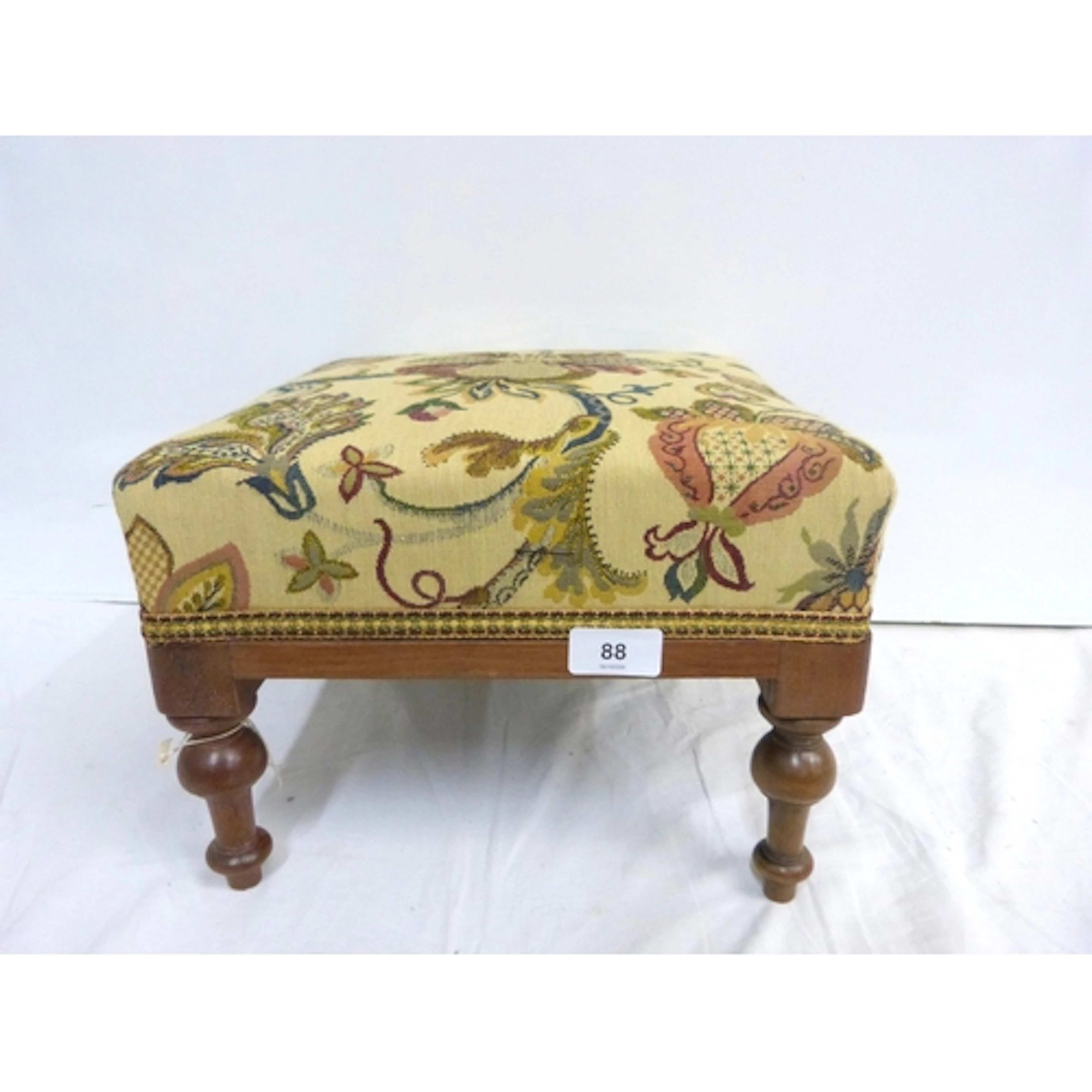 Small tapestry foot stool on turned supports.