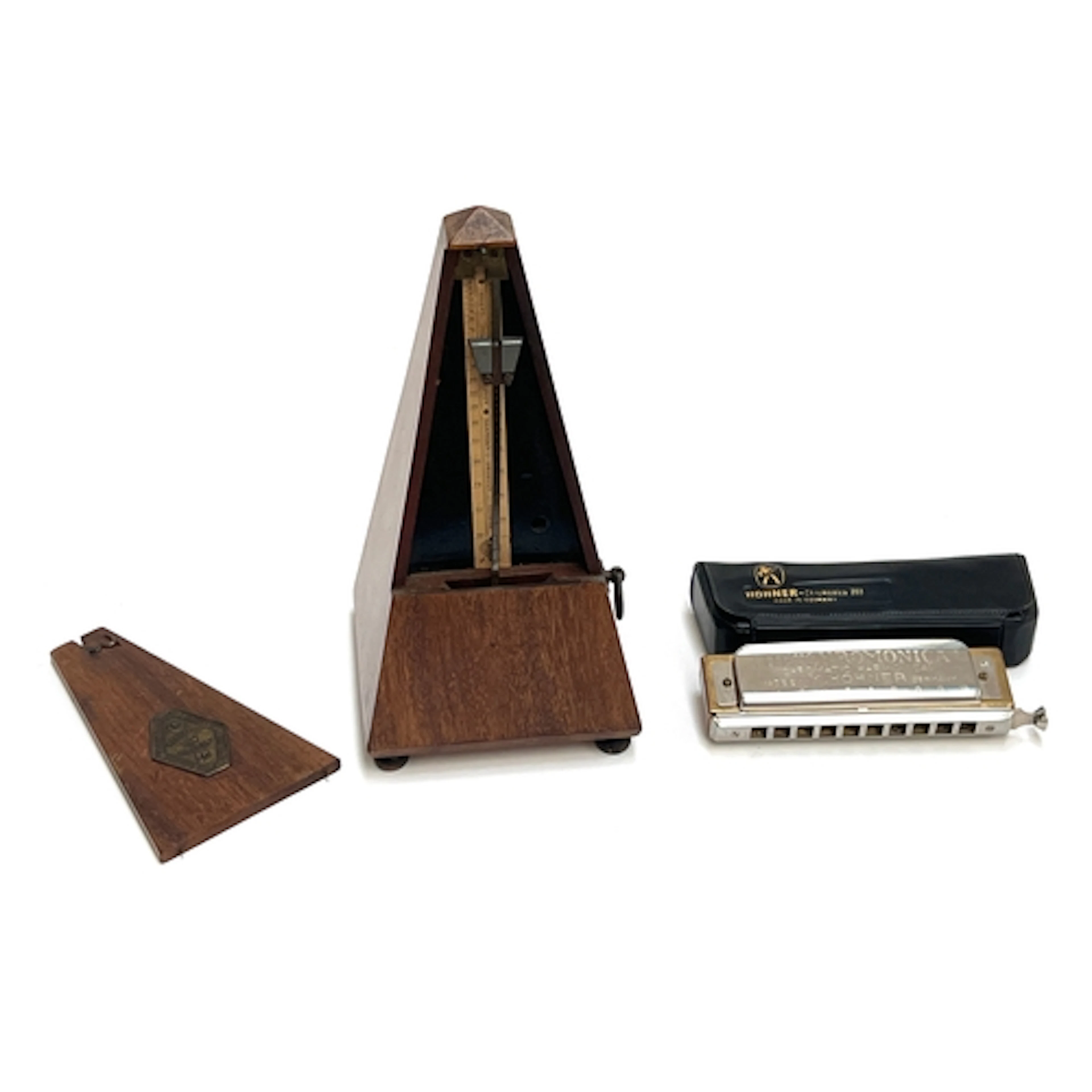 A vintage Maelzel metronome together with 'The Chromonica' c...