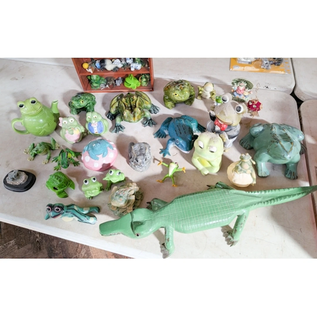 A large collection of assorted ornamental frogs and a model ...