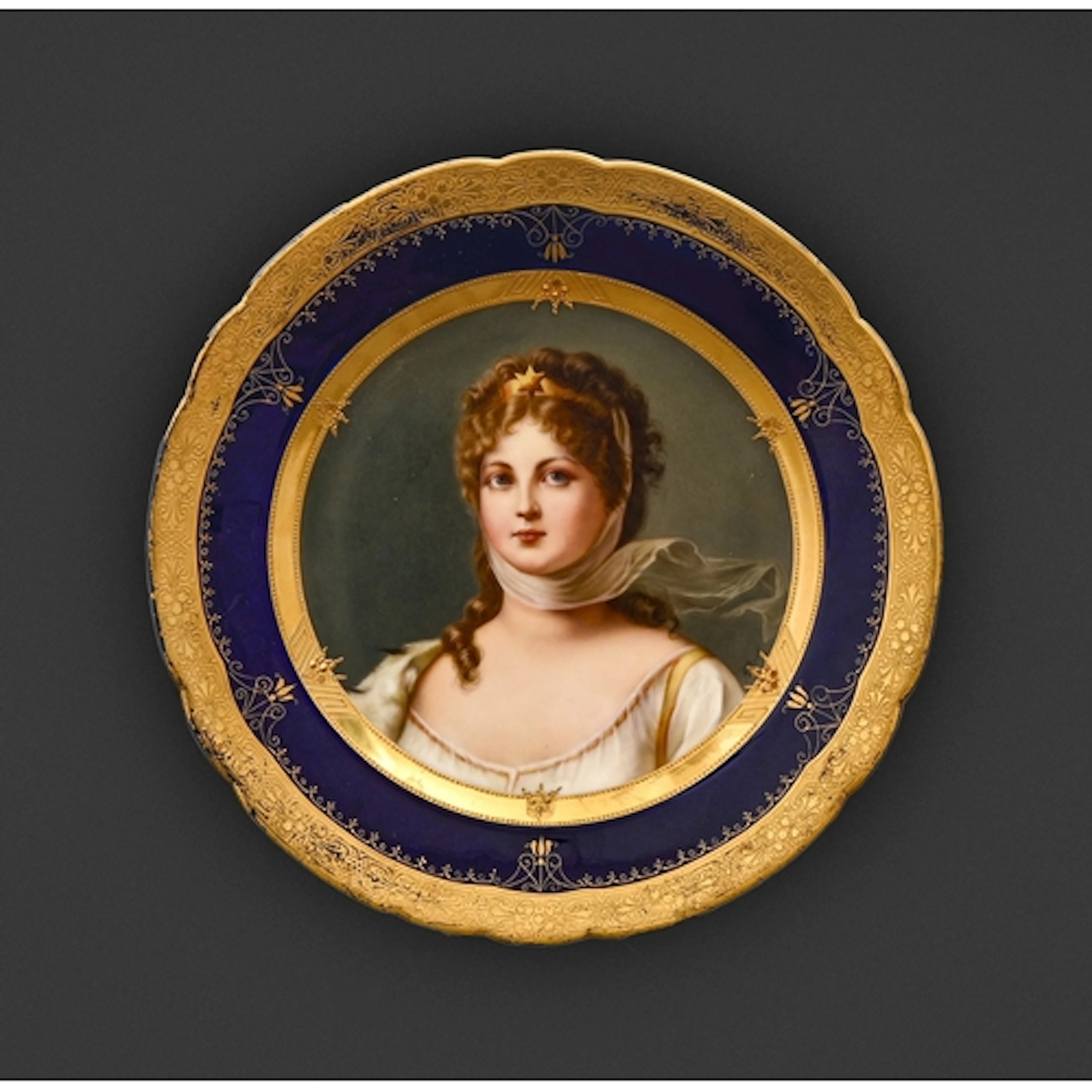 A Vienna style porcelain plate, early 20th c, painted by A B...