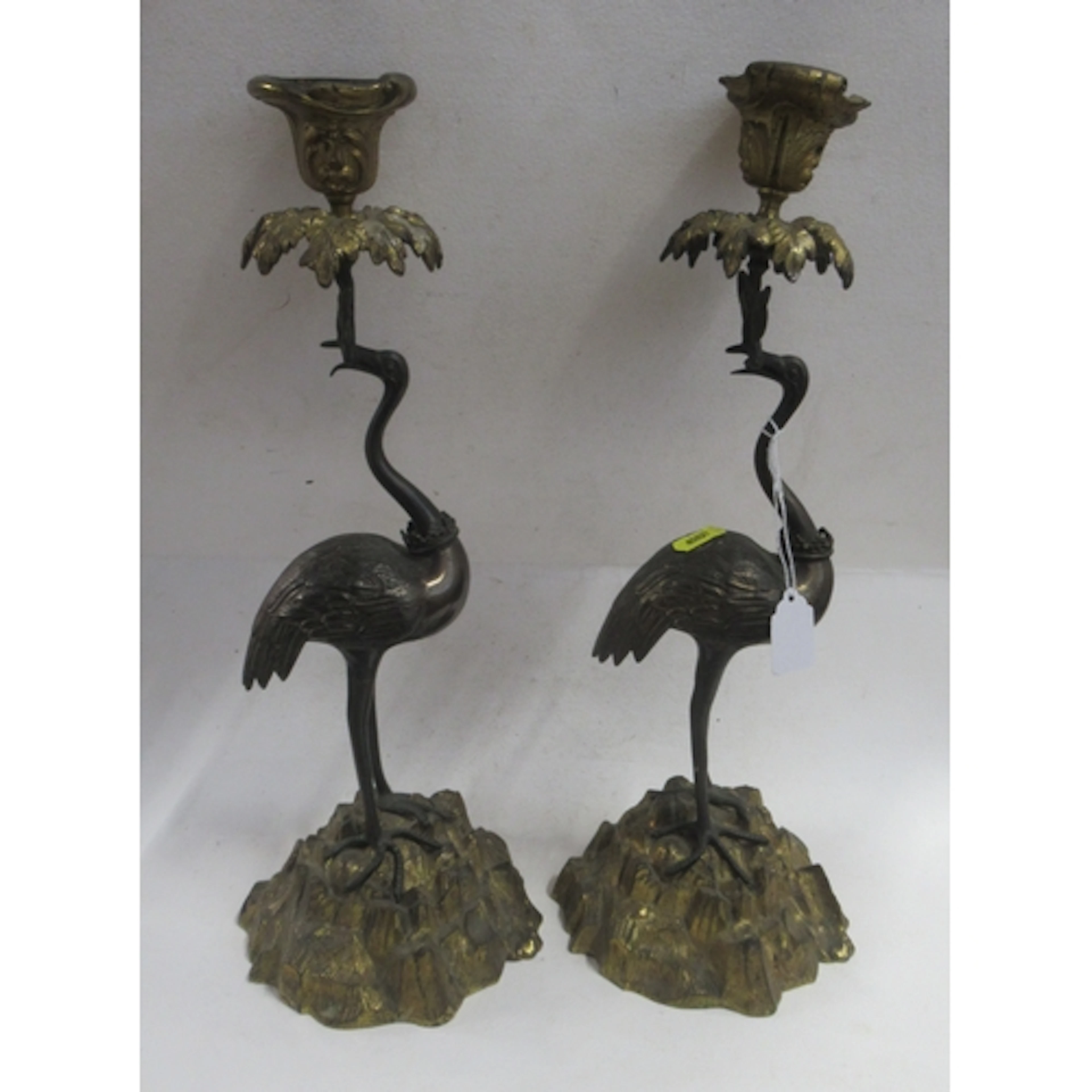 A pair of Victorian metal candlesticks, with gilded sconces ...