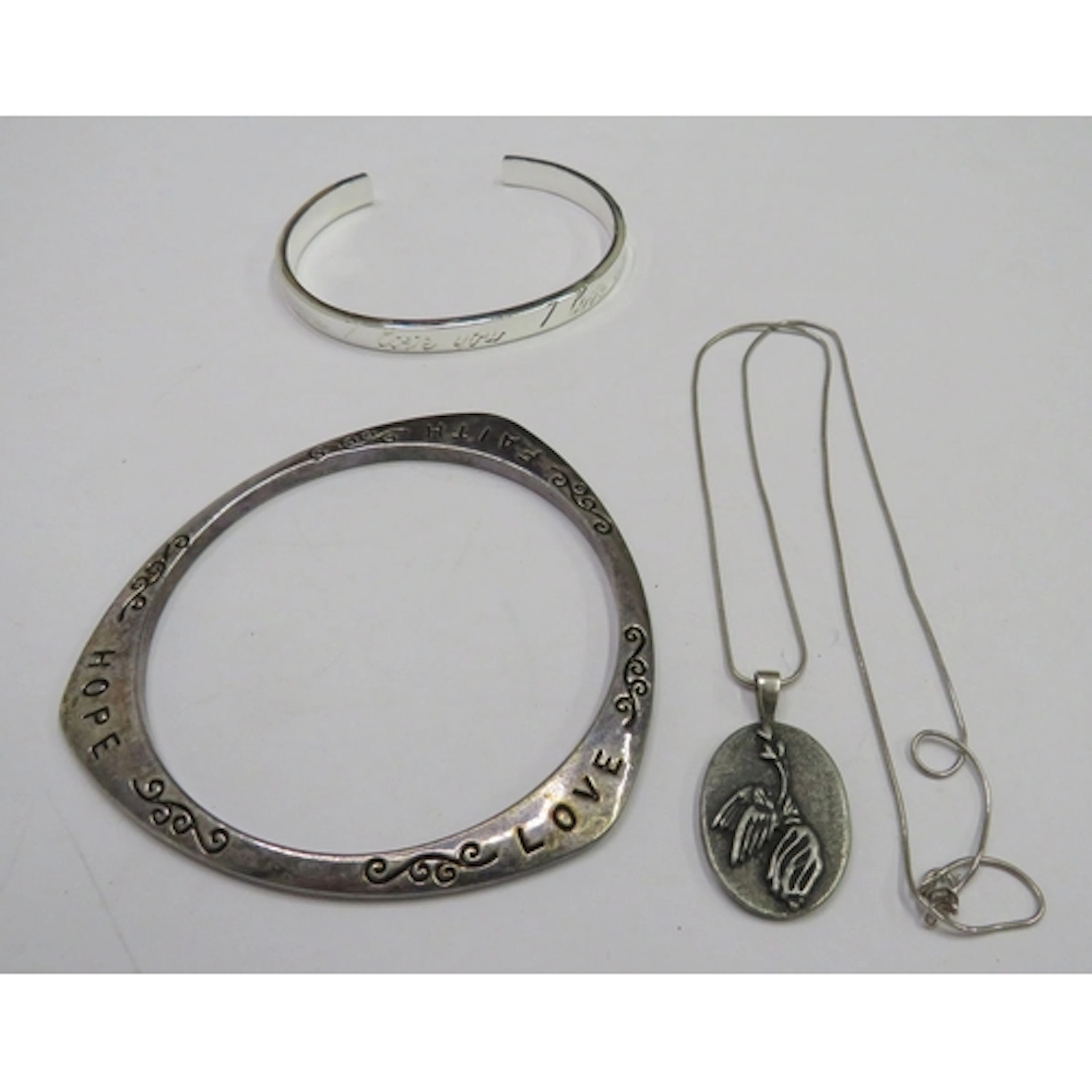 Triangular Shaped White Metal Bracelet marked 'Love Hope Fai...