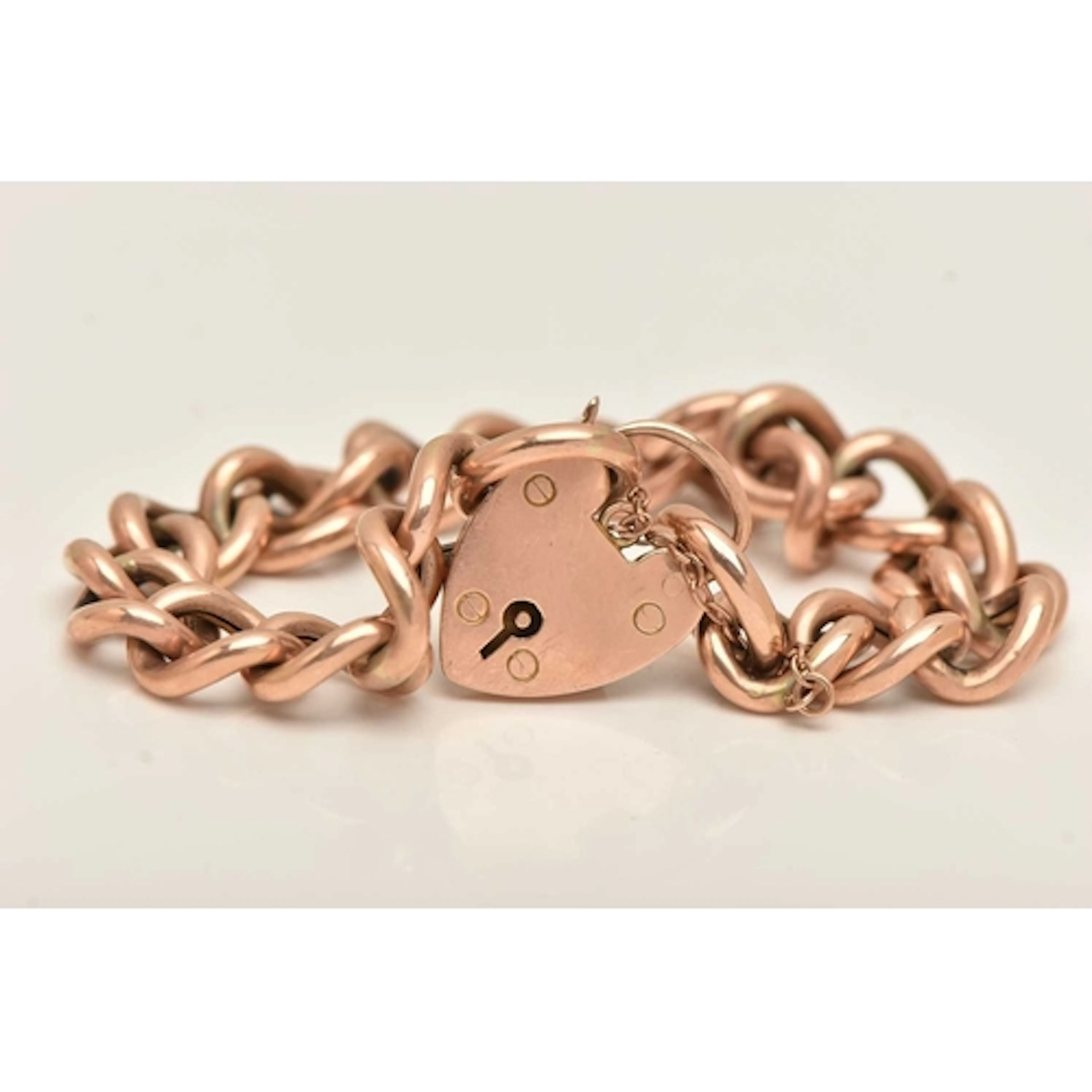 A ROSE METAL CURB LINK BRACELET, hollow curb links, fitted w...
