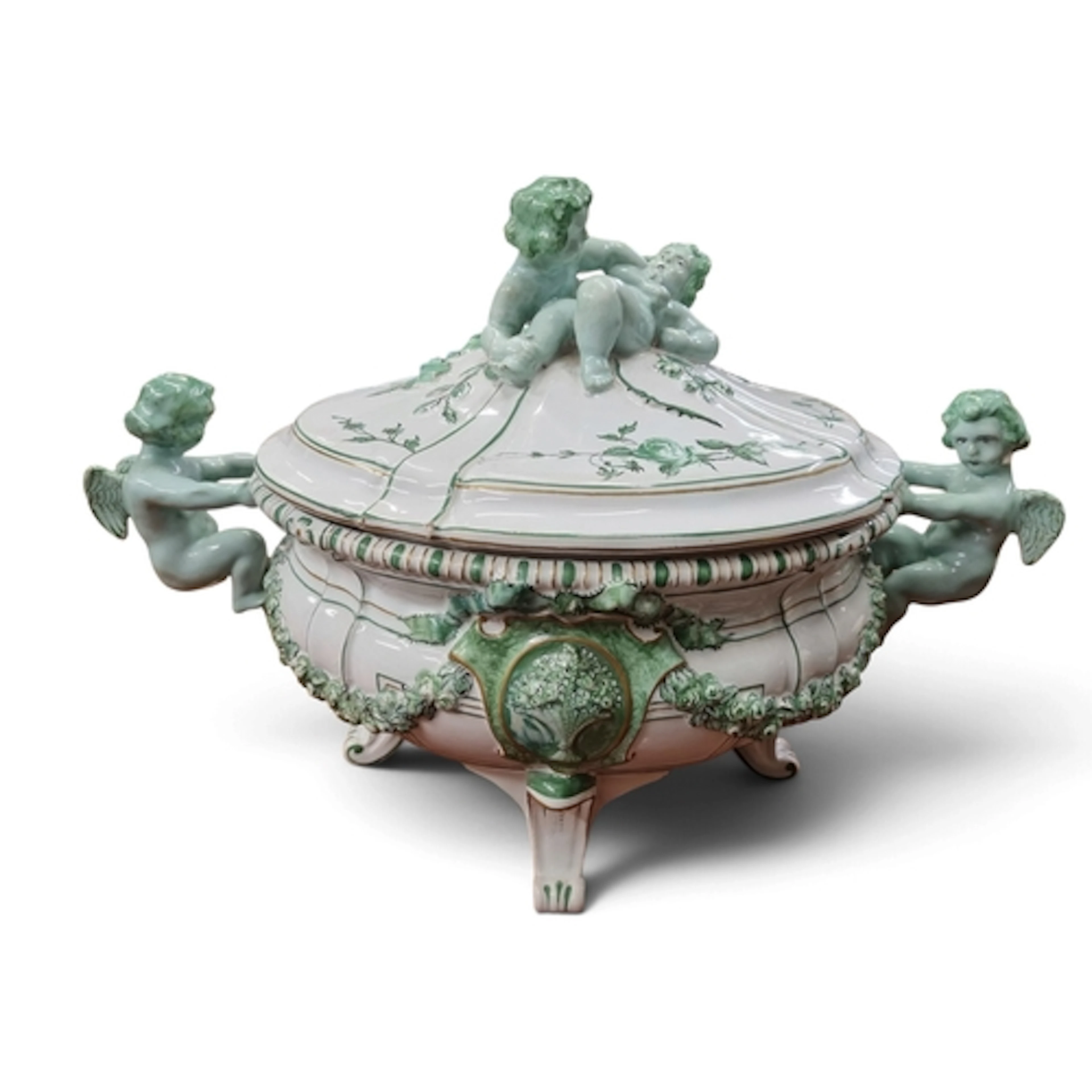A hand painted Pottery Soup Terrine depicting Cherubs suppor...