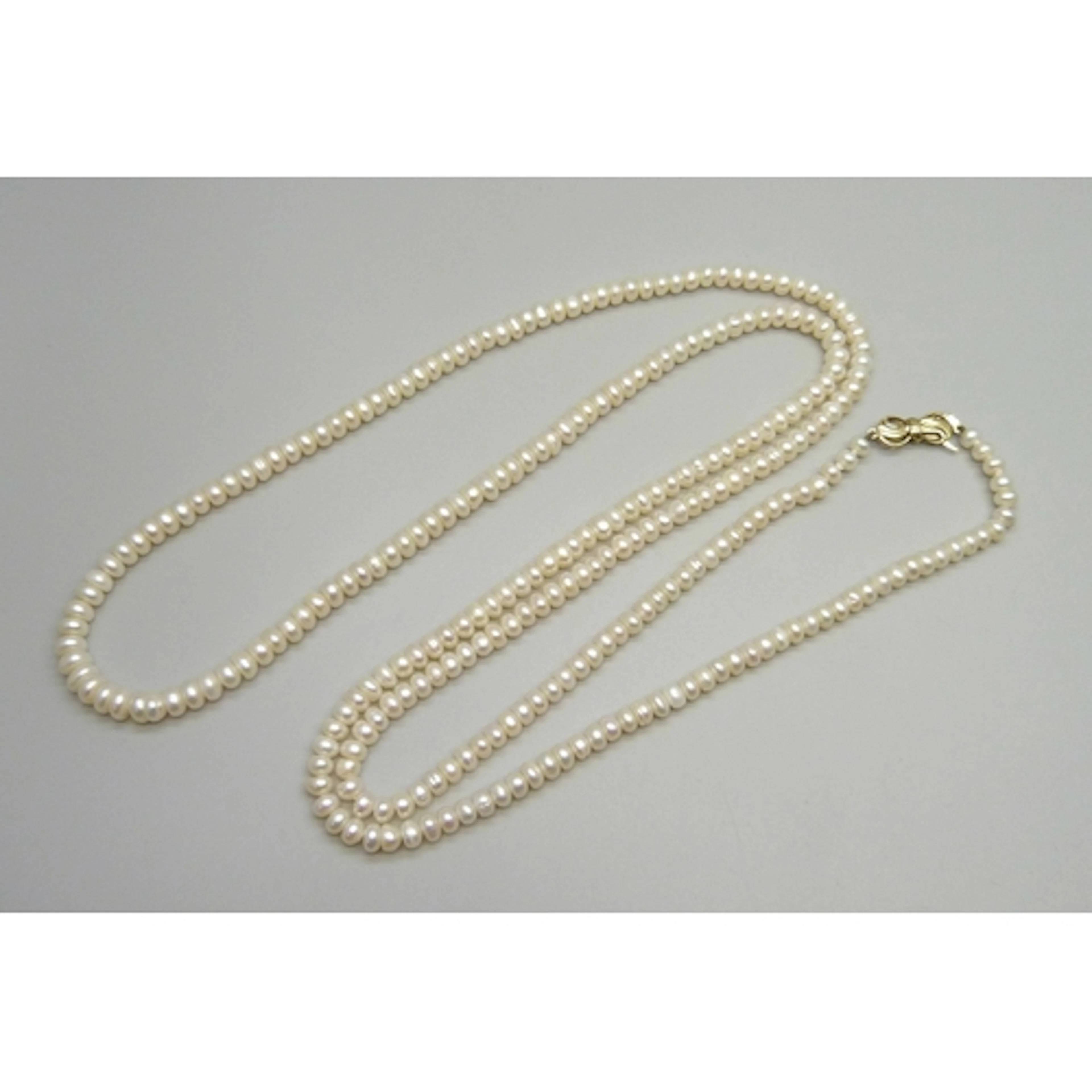 A long opera length pearl necklace with a 9ct gold clasp, 46...