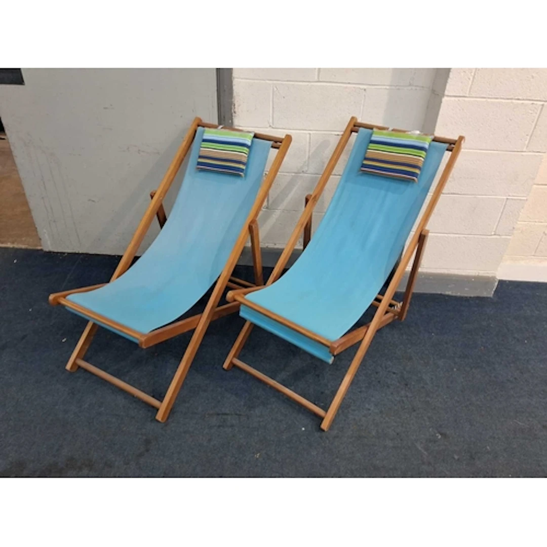 A PAIR OF MODERN BEECH FOLDING DECK CHAIRS, with blue fabric...