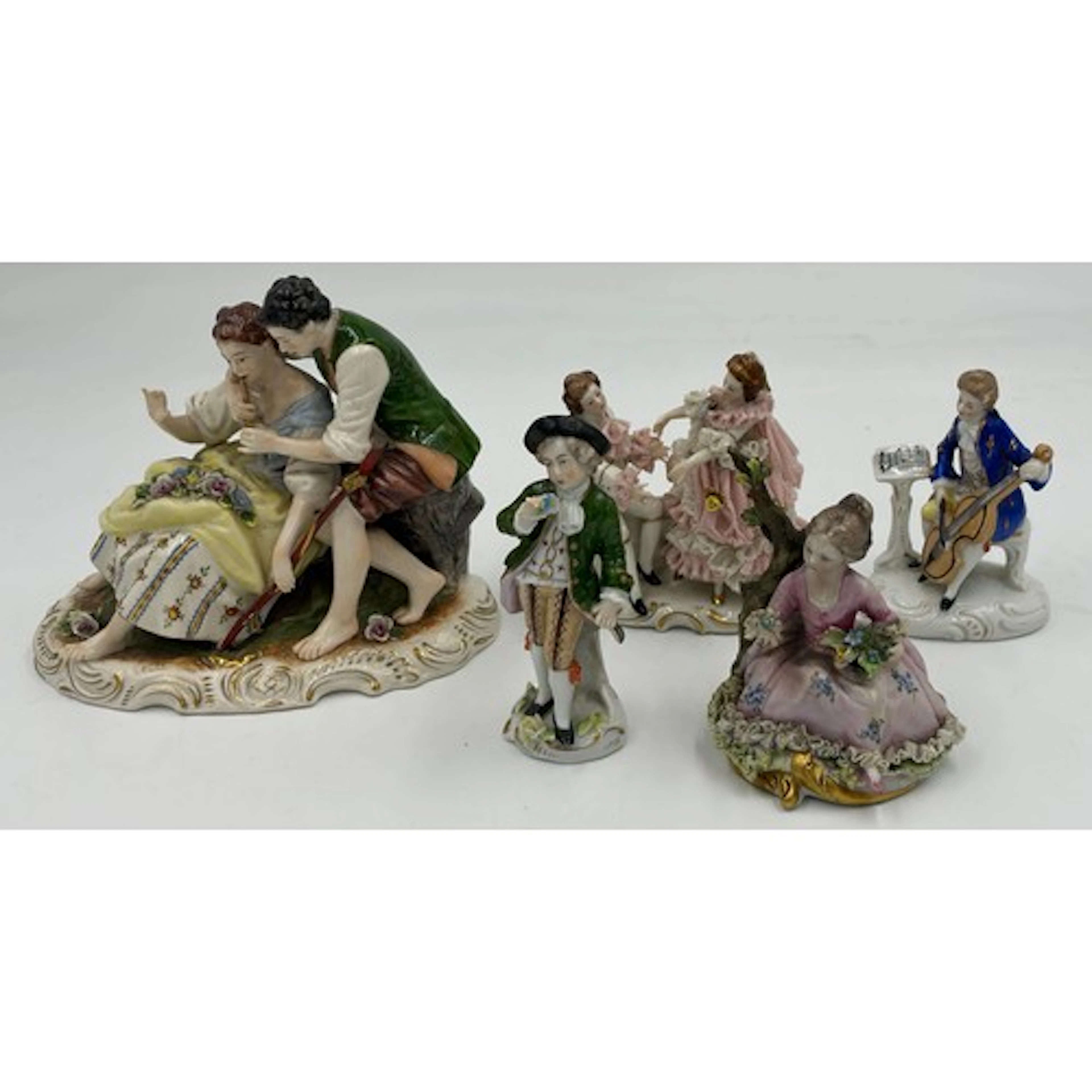 A collection of Dresden figurines to include a courting coup...