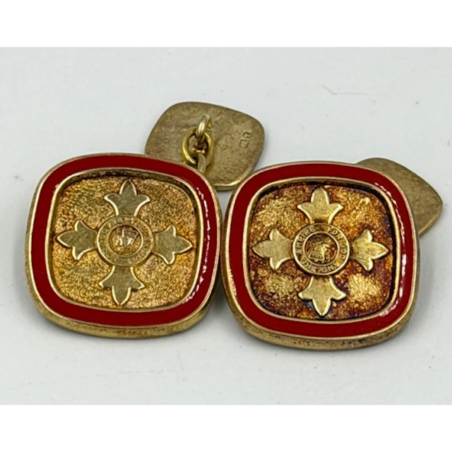 A pair of silver gilt cufflinks with central design and mott...