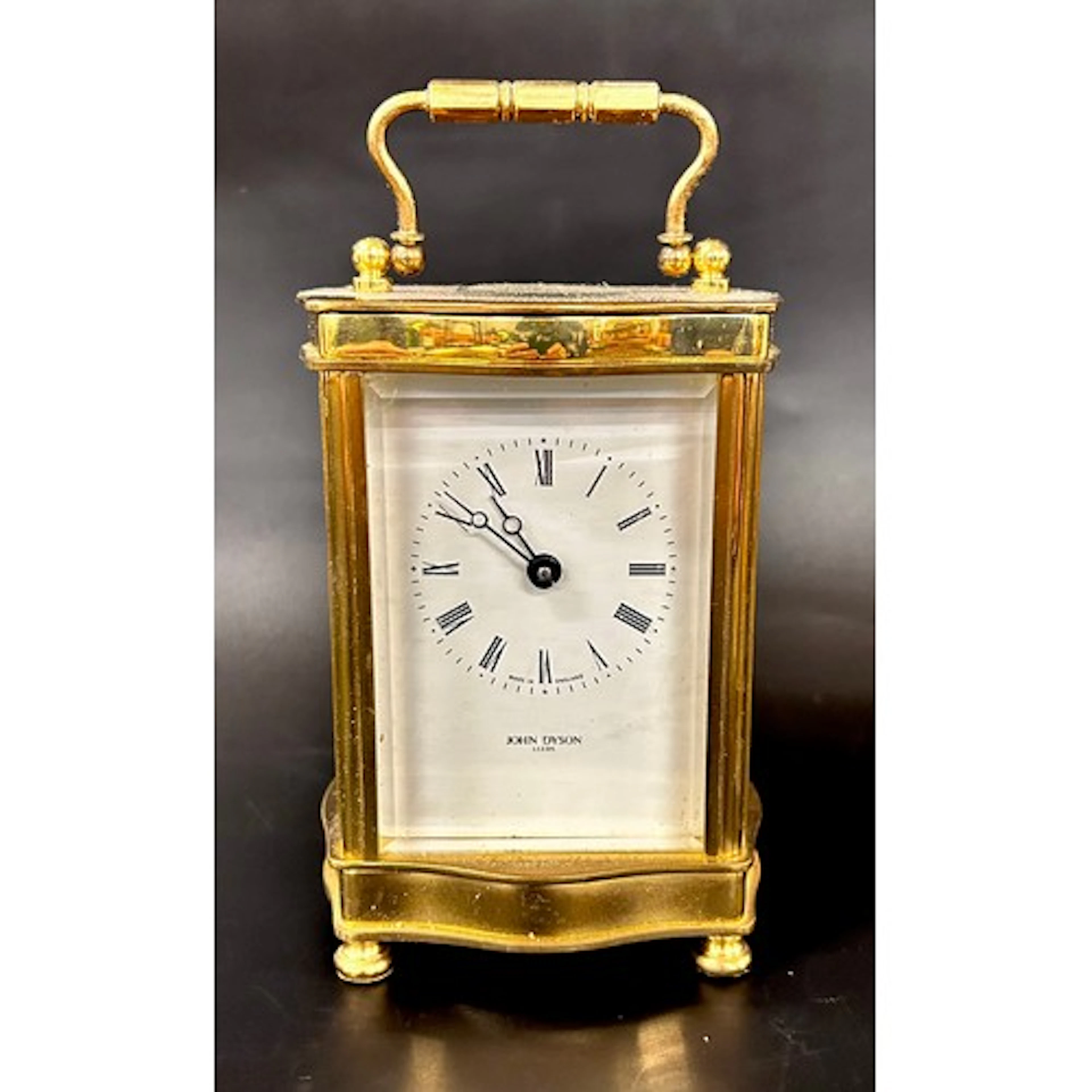 A John Dyson brass serpentine carriage clock, movement made ...