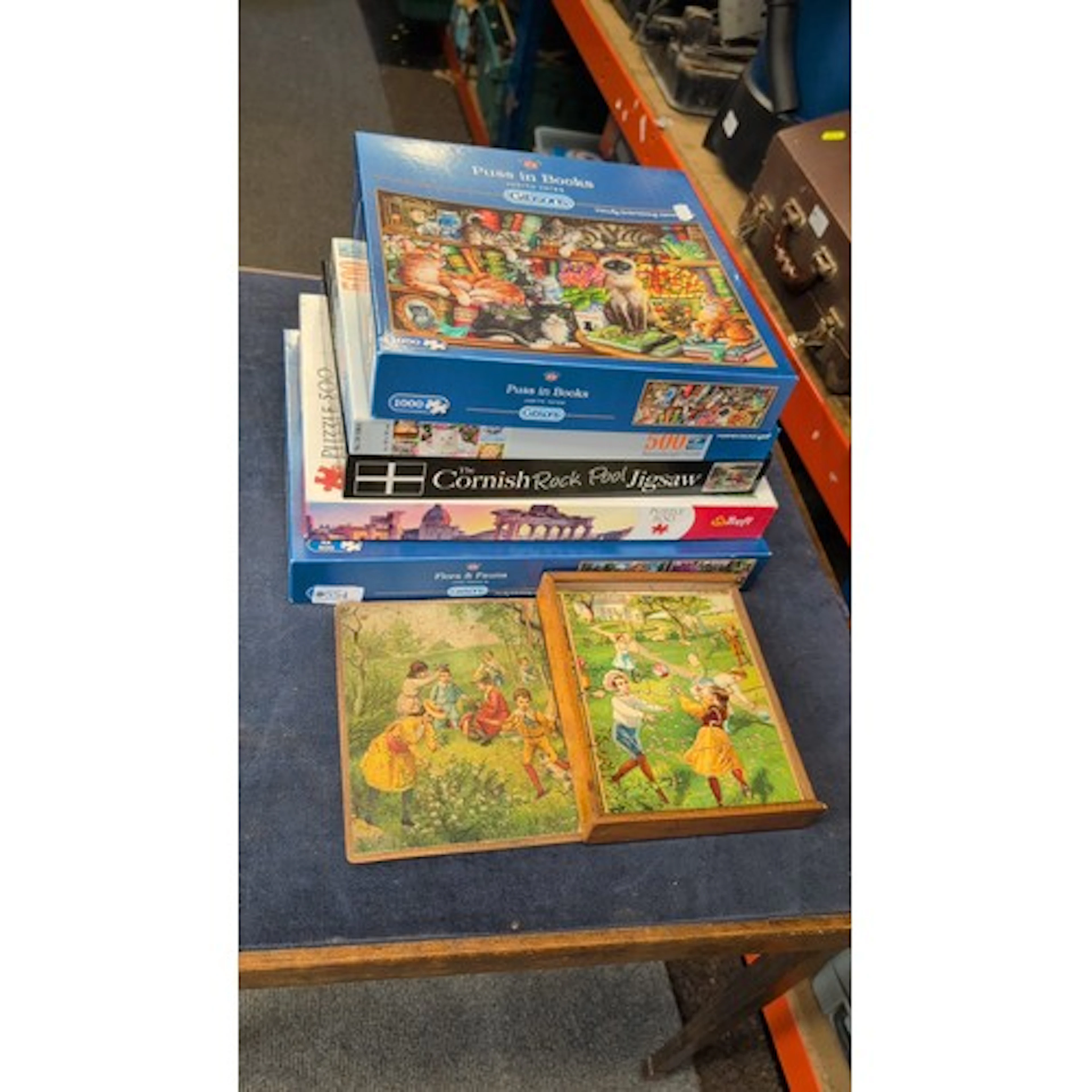 A group of jigsaw puzzles, including Gibsons titles ‘Puss in...
