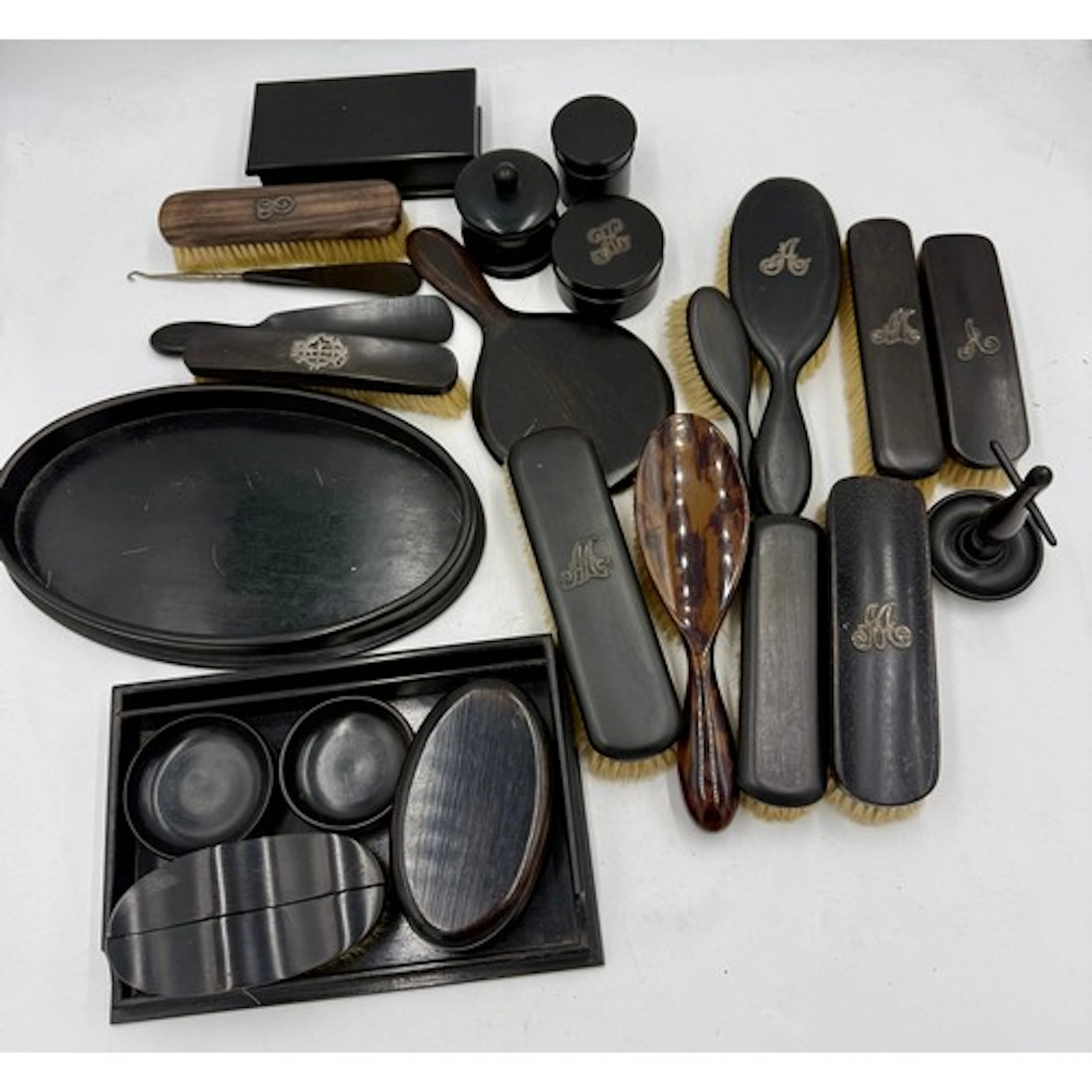 A quantity of ebony dressing table accoutrements to include ...