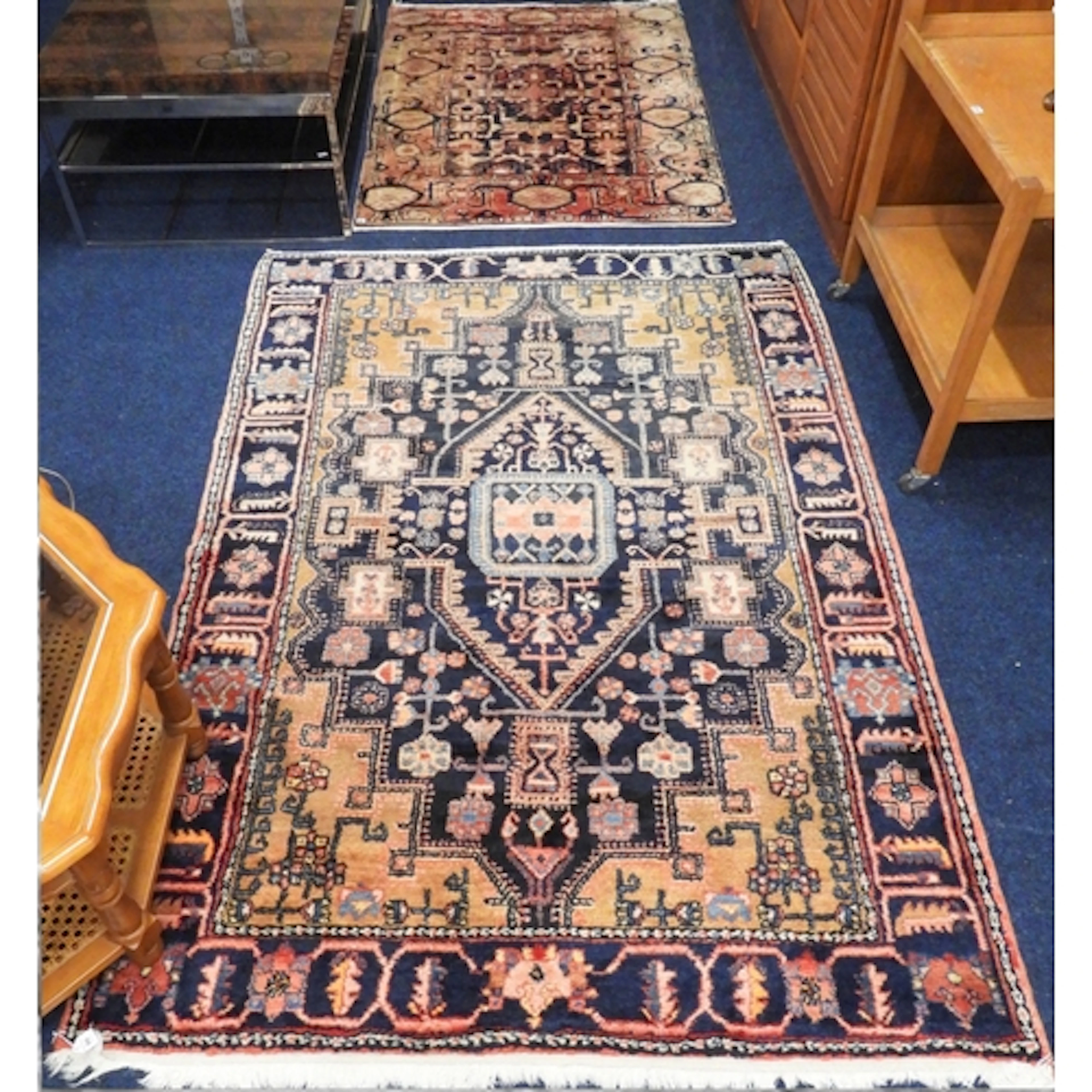 A lot comprising a dark blue ground Hamadan rug with multico...