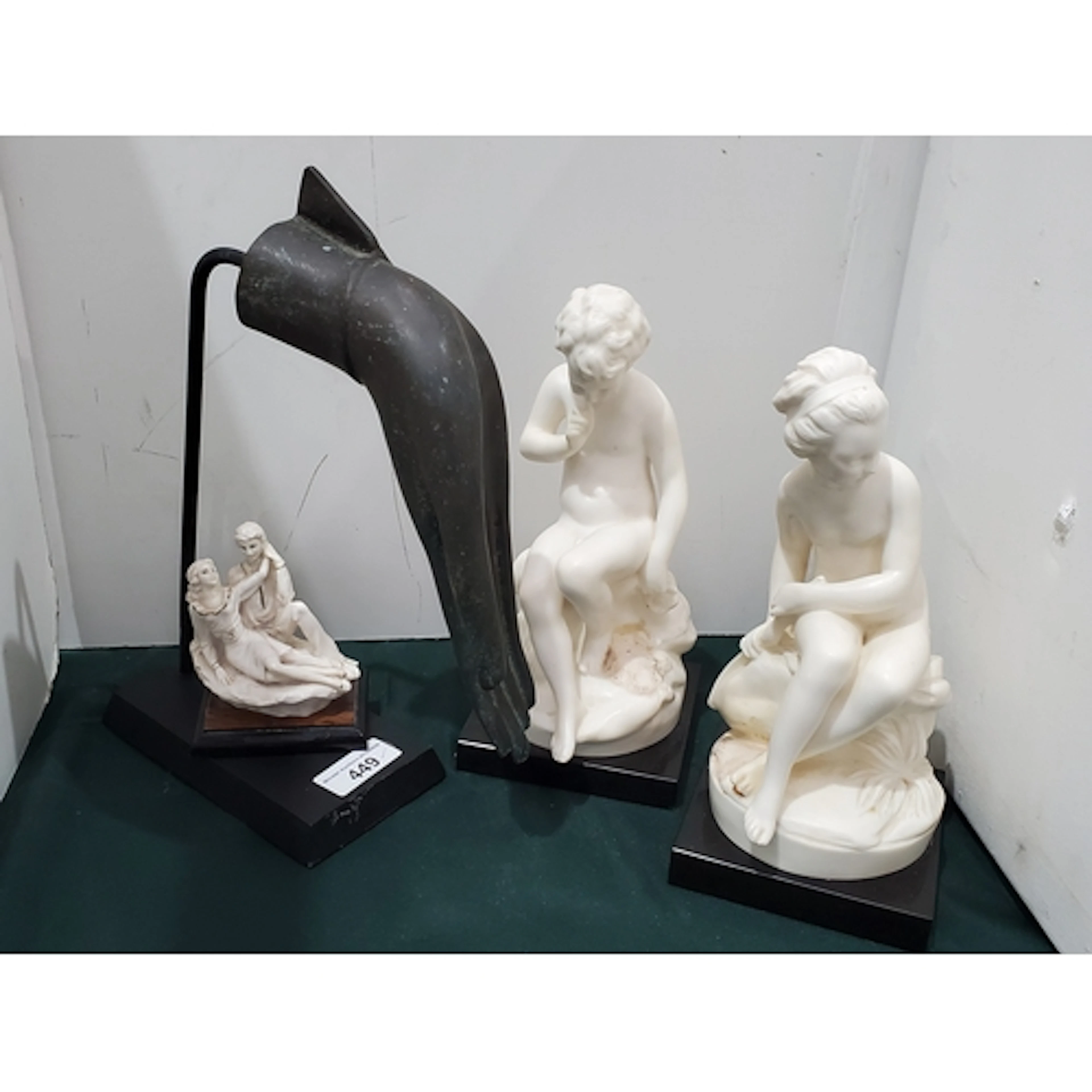 A metal Sculpture of a Hand, a figure of a Cherub, another f...