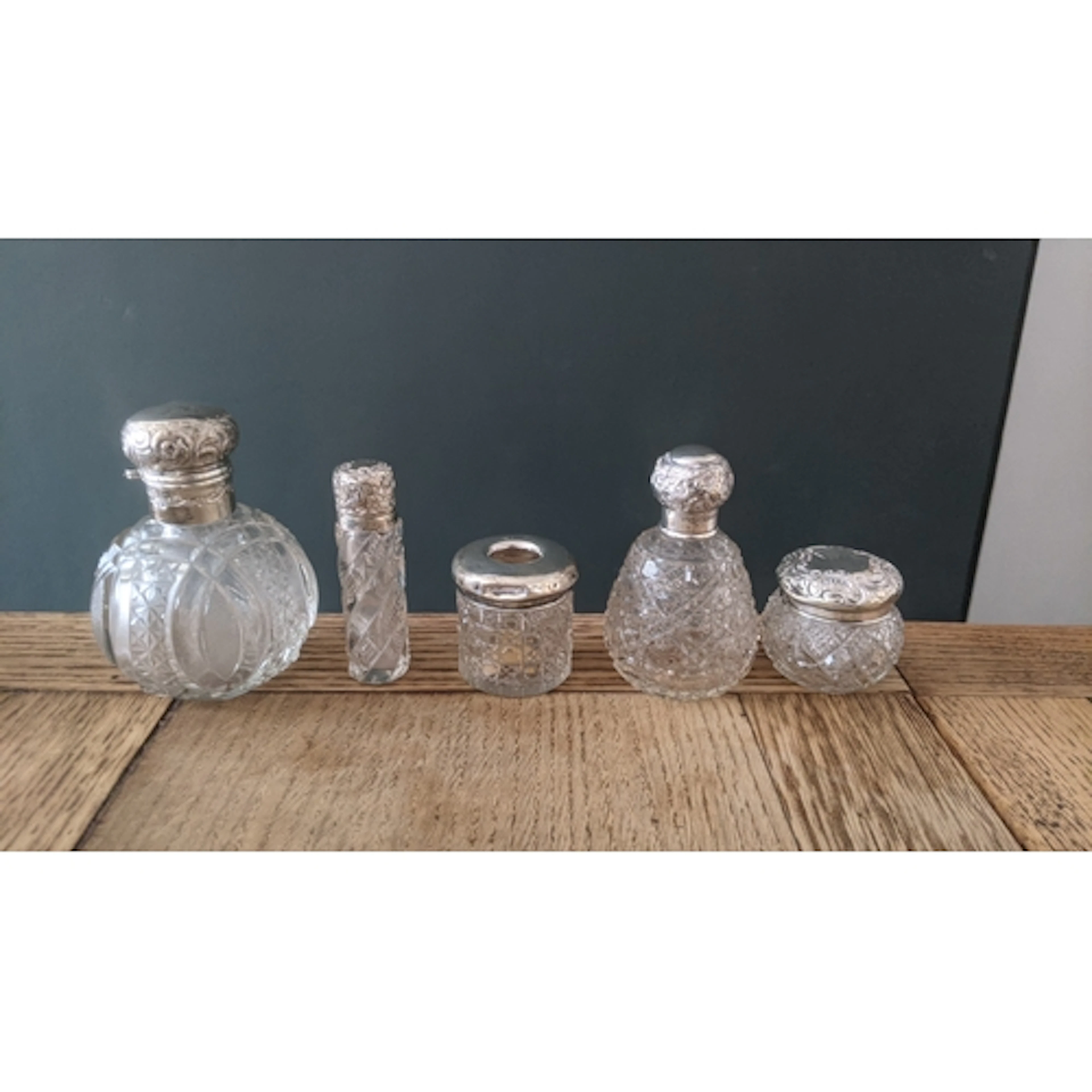A collection of silver topped crystal cut glass dressing tab...
