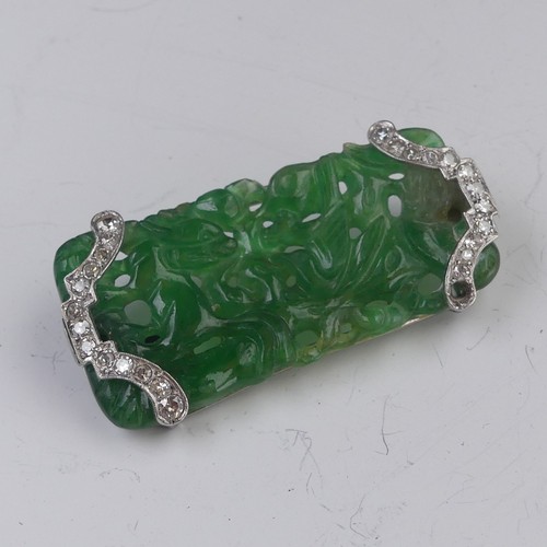 A carved jade Brooch, pierced with Fu dog and bird decoratio...