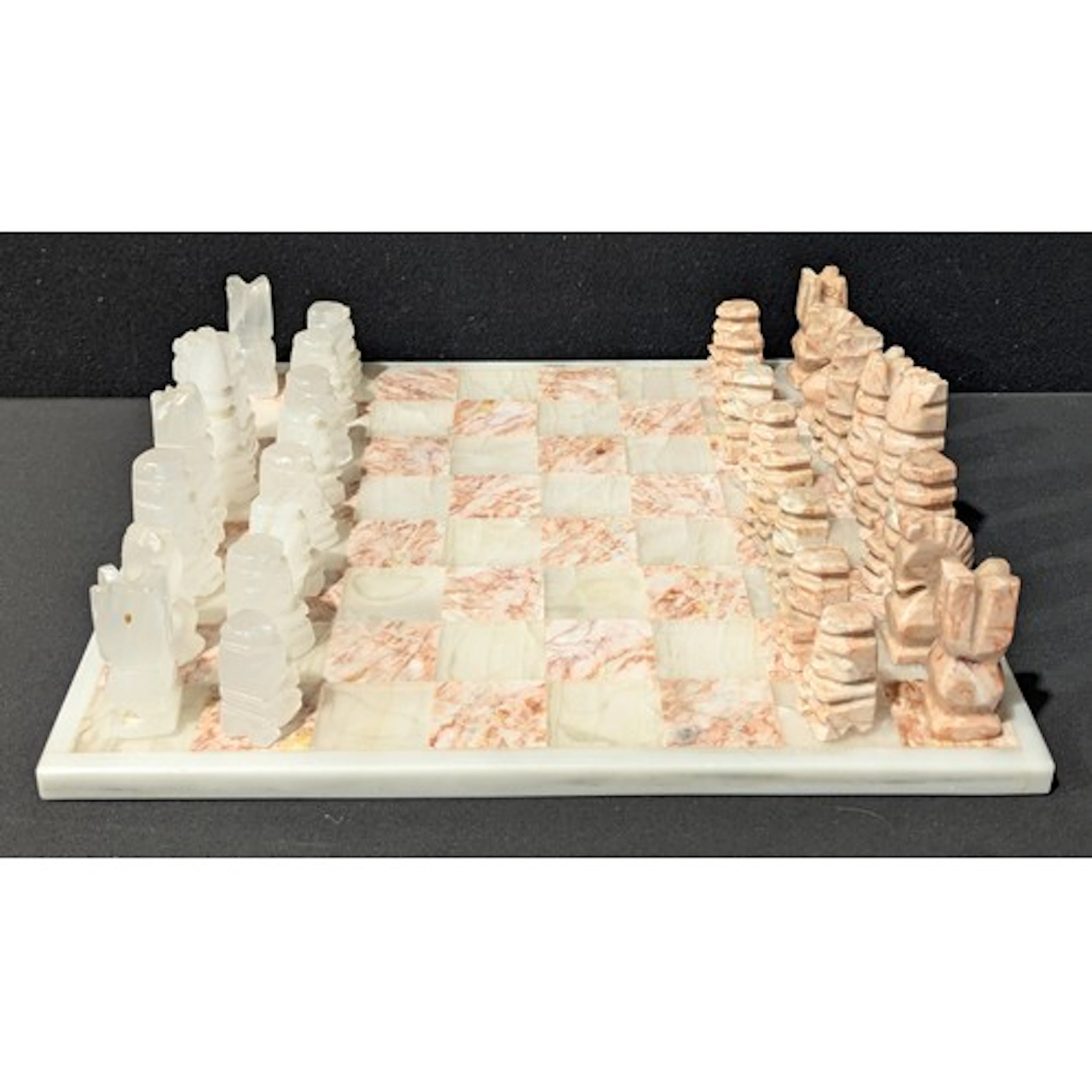 A decorative carved onyx chess set in the aztec style, 35cm ...