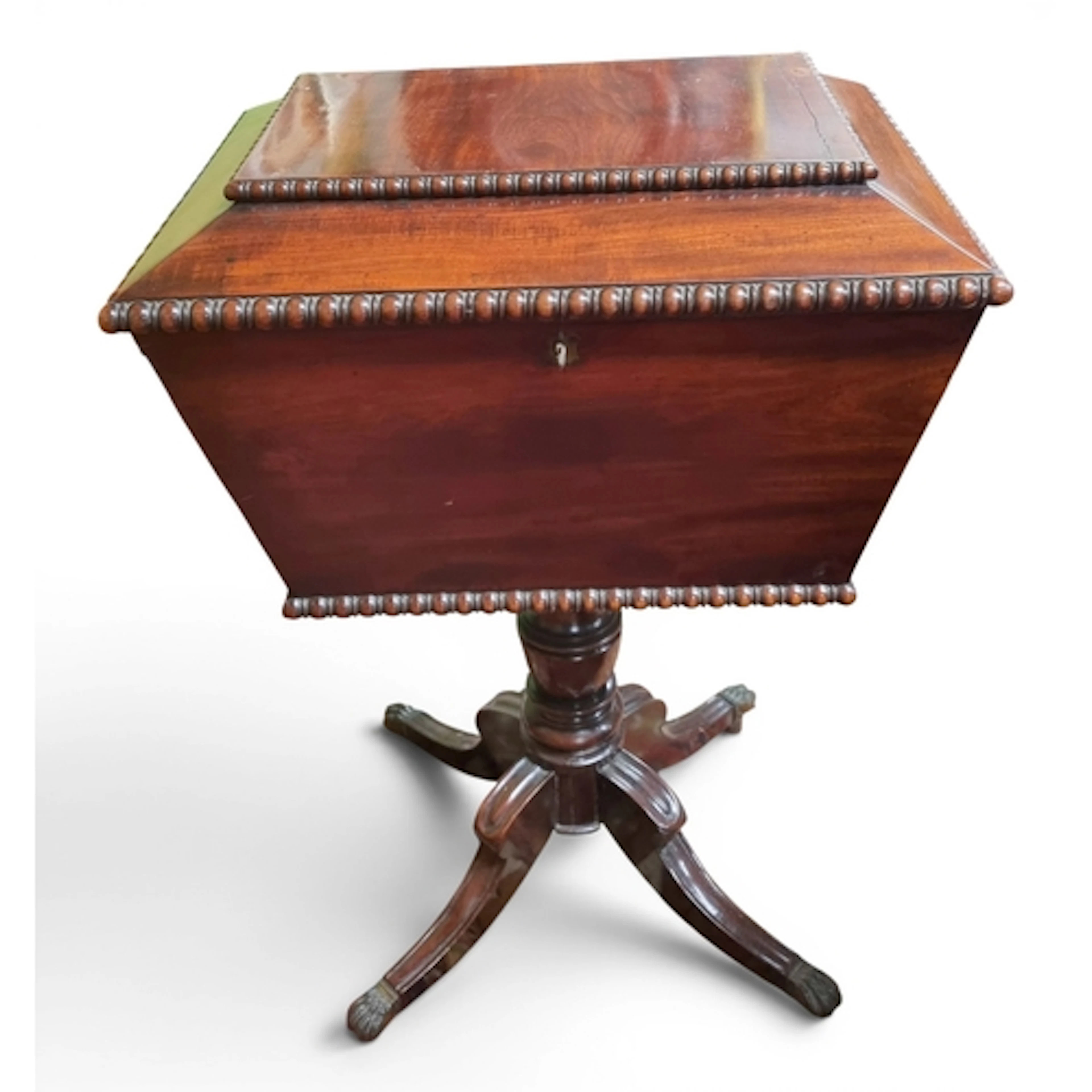 An early 19th Century Mahogany Teapoy on quatrefoil supports...