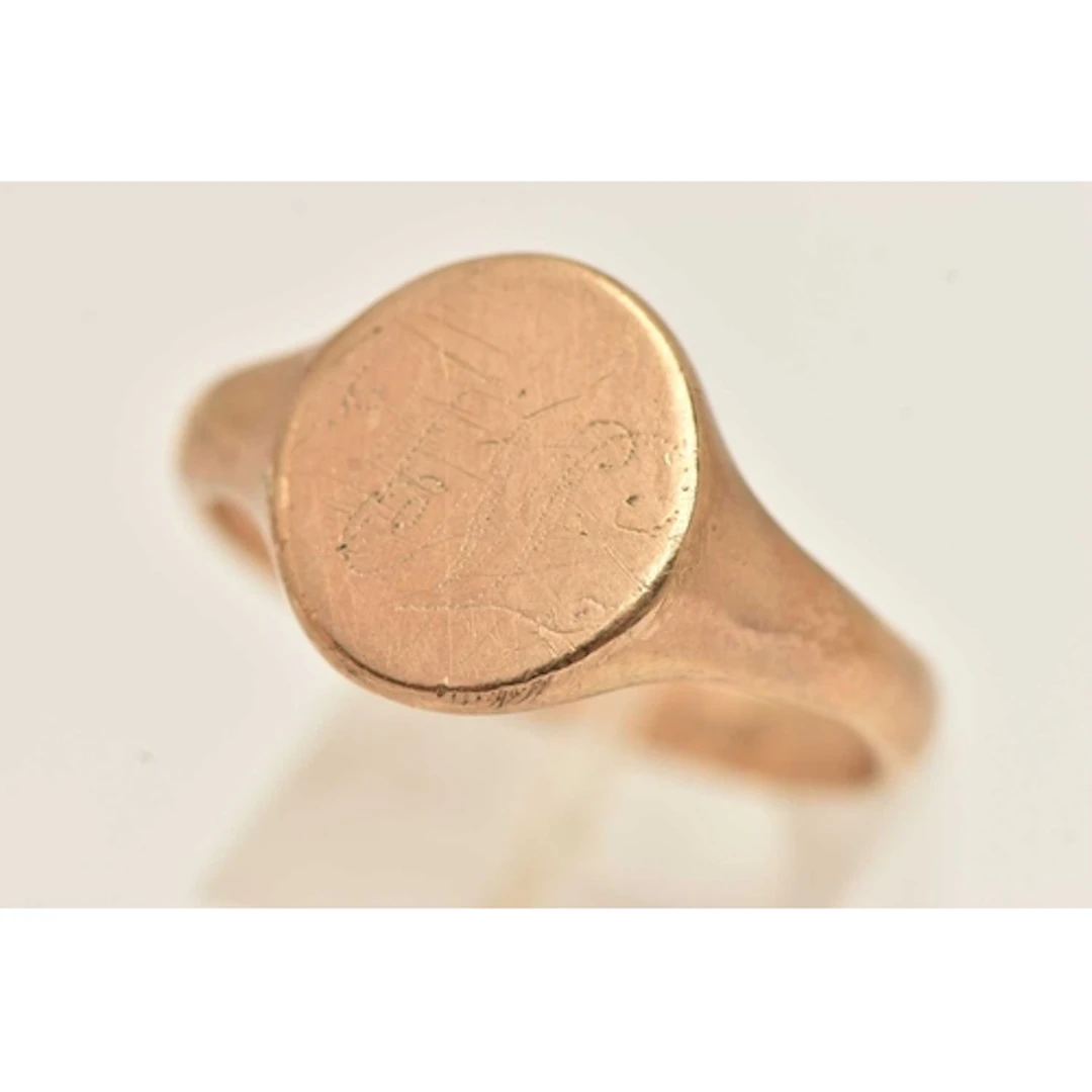 A HEAVY 9CT GOLD OVAL SIGNET RING, of an oval form, worn enr...