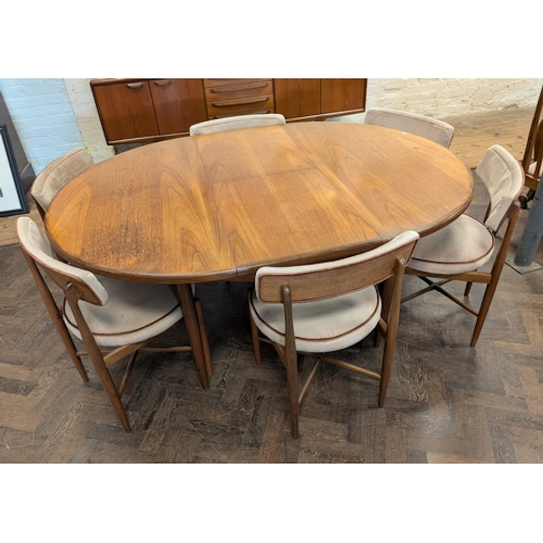 A 1960's/1970's G-plan teak oval extending dining table toge...