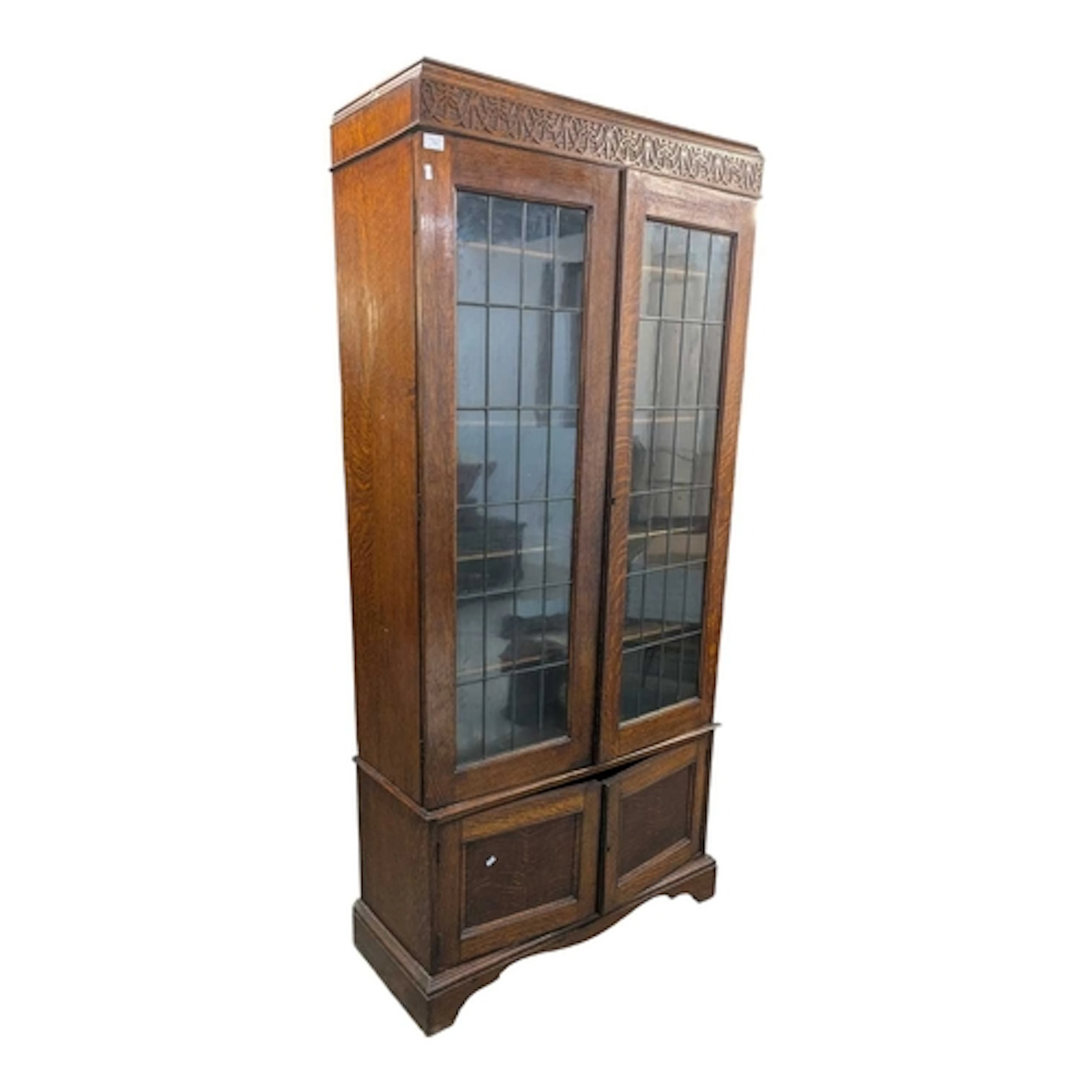 A vintage 20th century Jacobean revival bookcase cabinet. Ha...