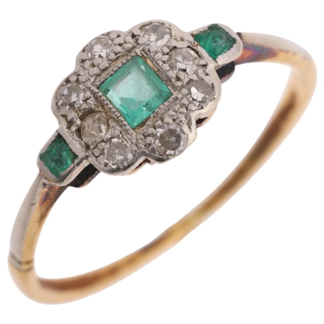 An 18ct gold emerald and diamond cluster ring, in the Art De...
