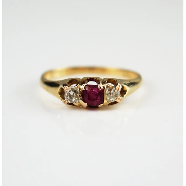A ruby and old cut diamond three stone ring in a high carat ...