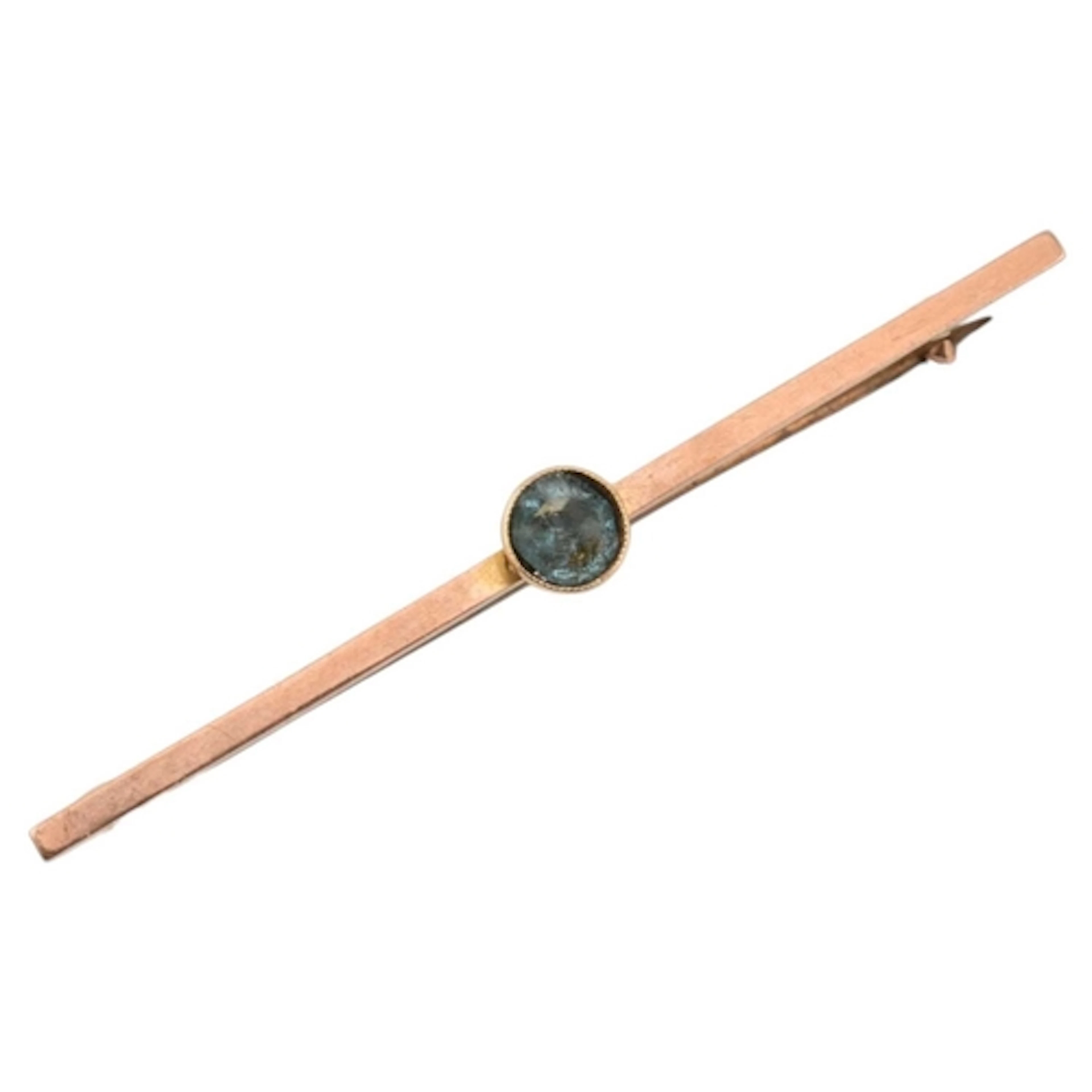A 9ct gold and blue abraded stone brooch pin. Stone set in t...