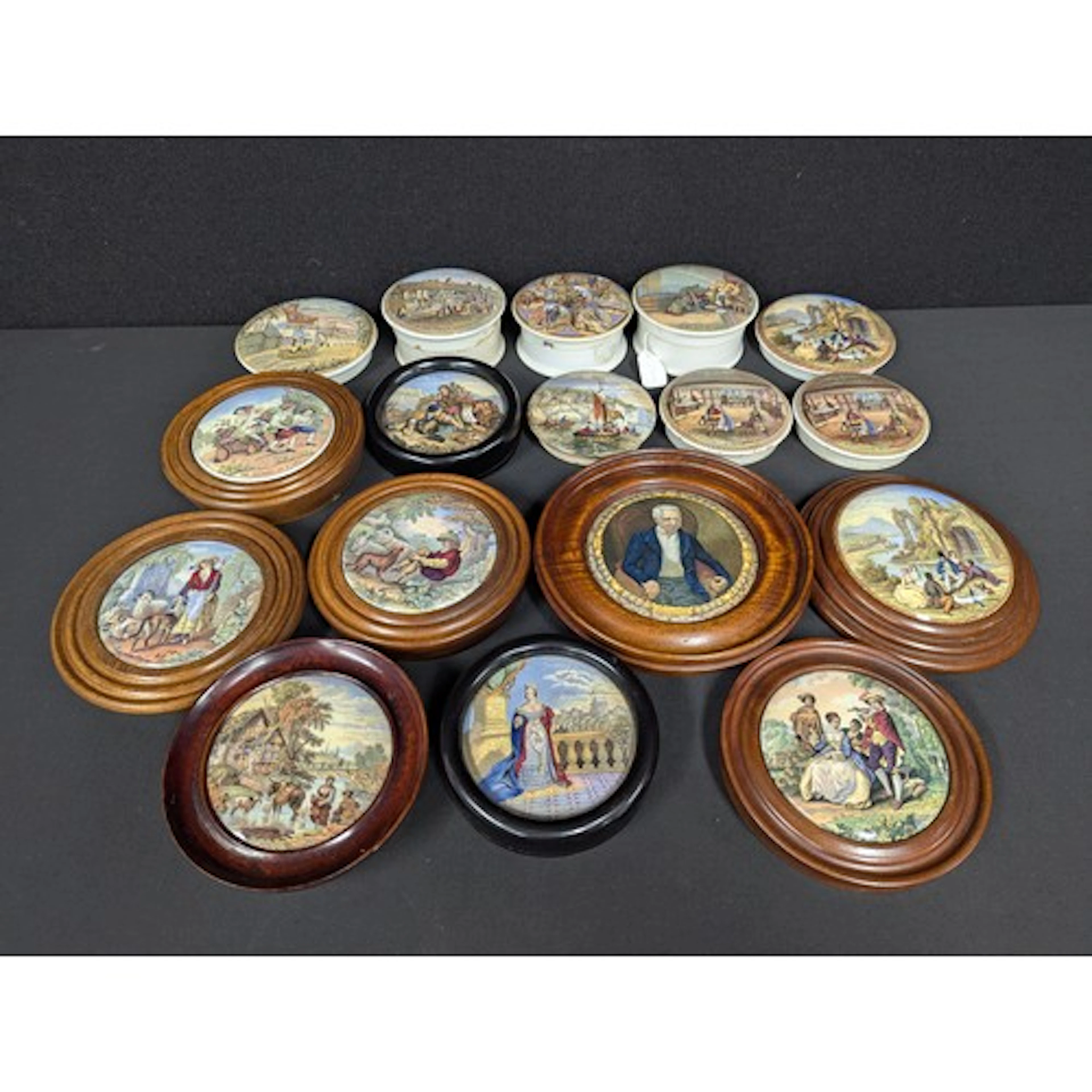 A collection of seventeen prattware pot lids, part framed or...