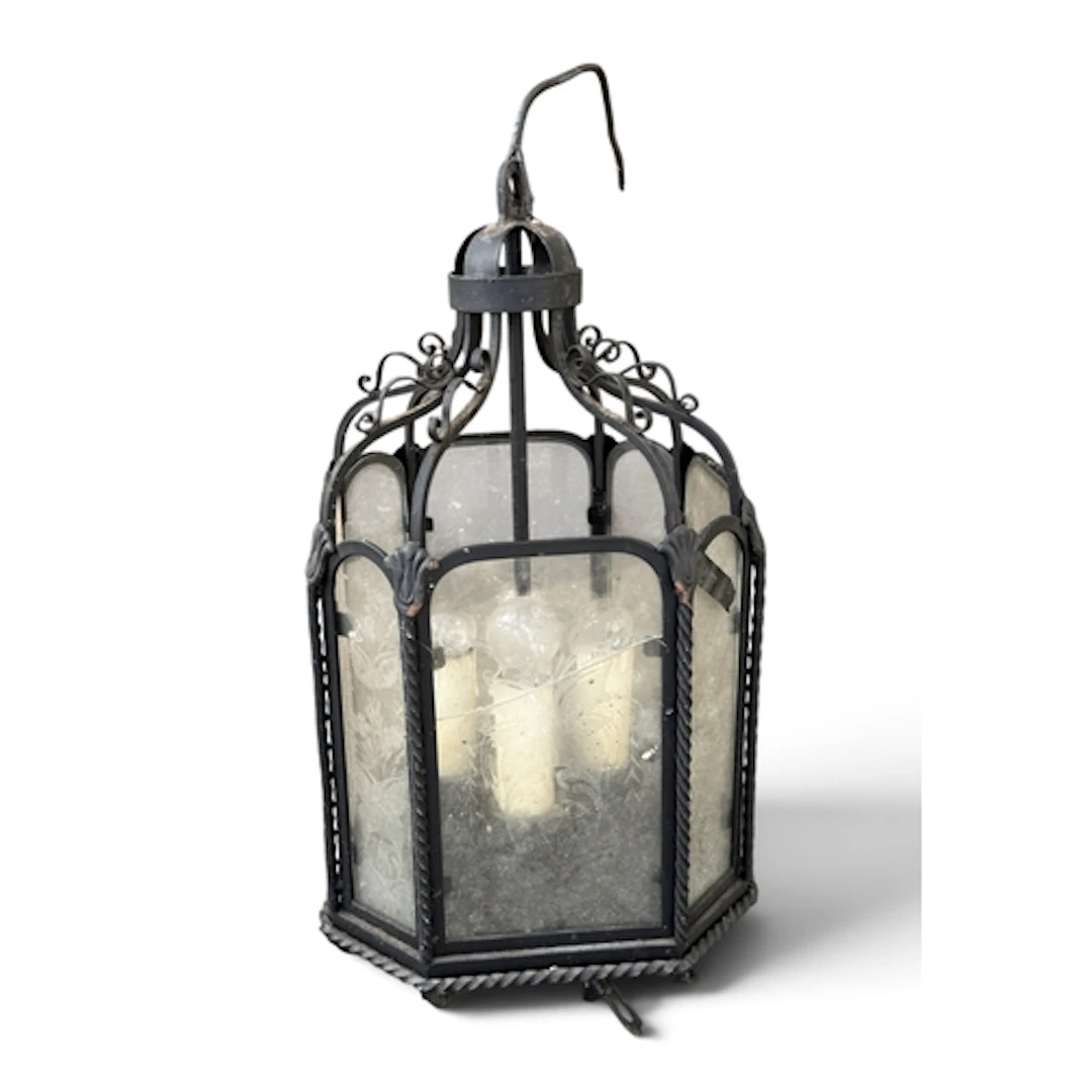 A CAST IRON LANTERN WITH GLASS PANEL SIDES One cracked panel...
