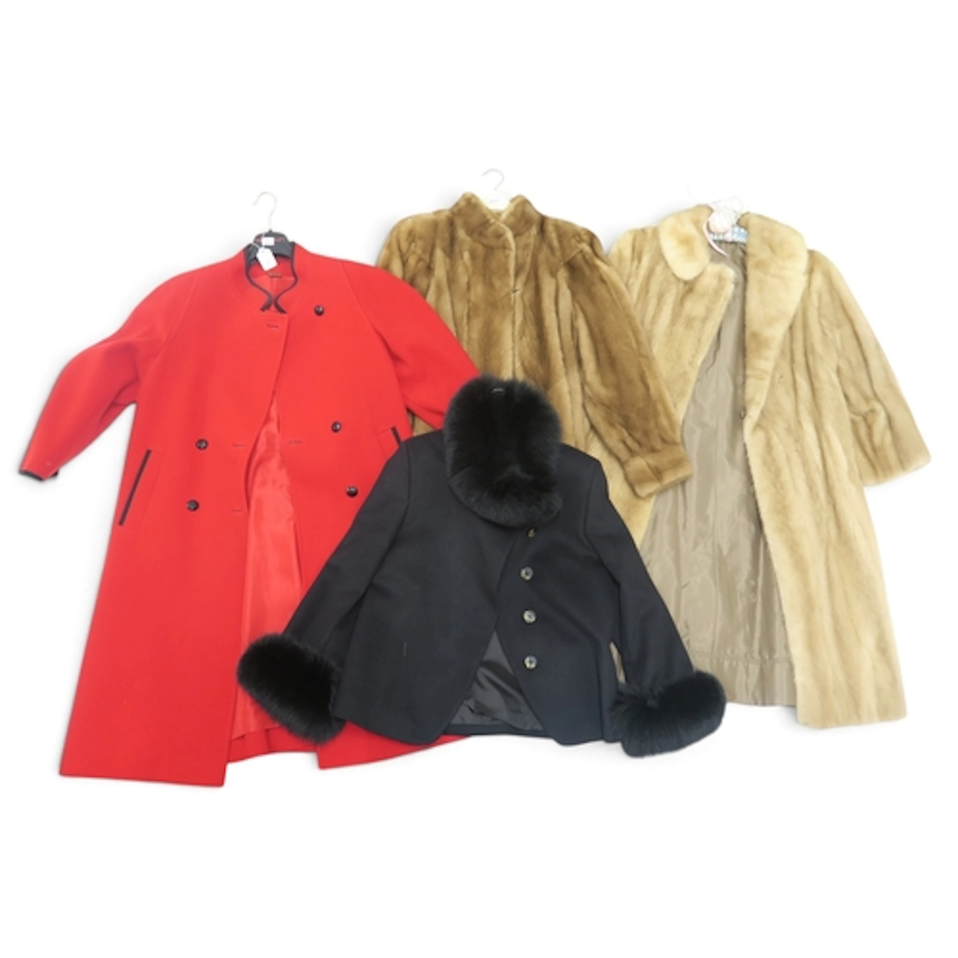 A blonde mink coat, a mink jacket with scalloped hem, a blac...
