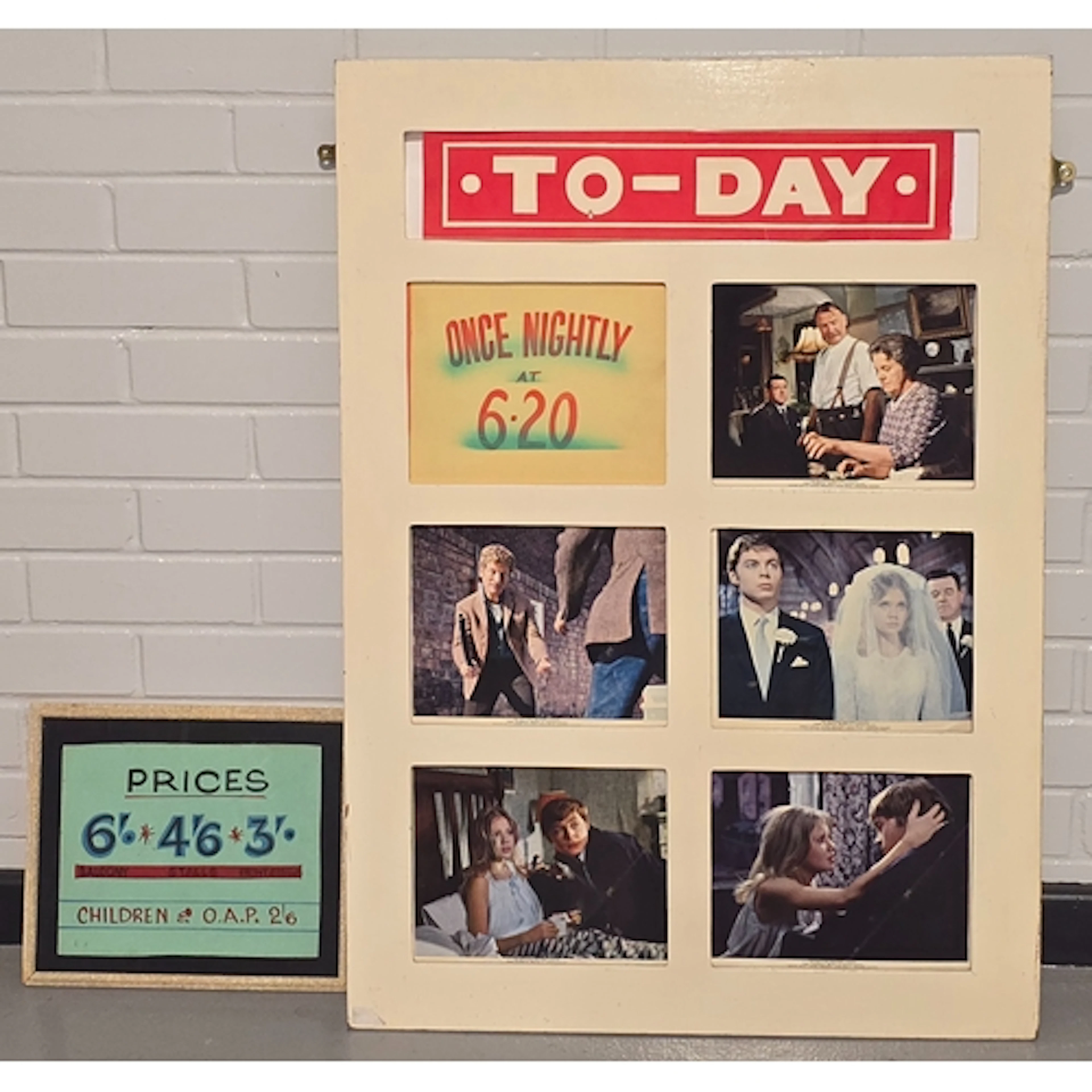 A vintage wooden Cinema lobby card display board with a set ...
