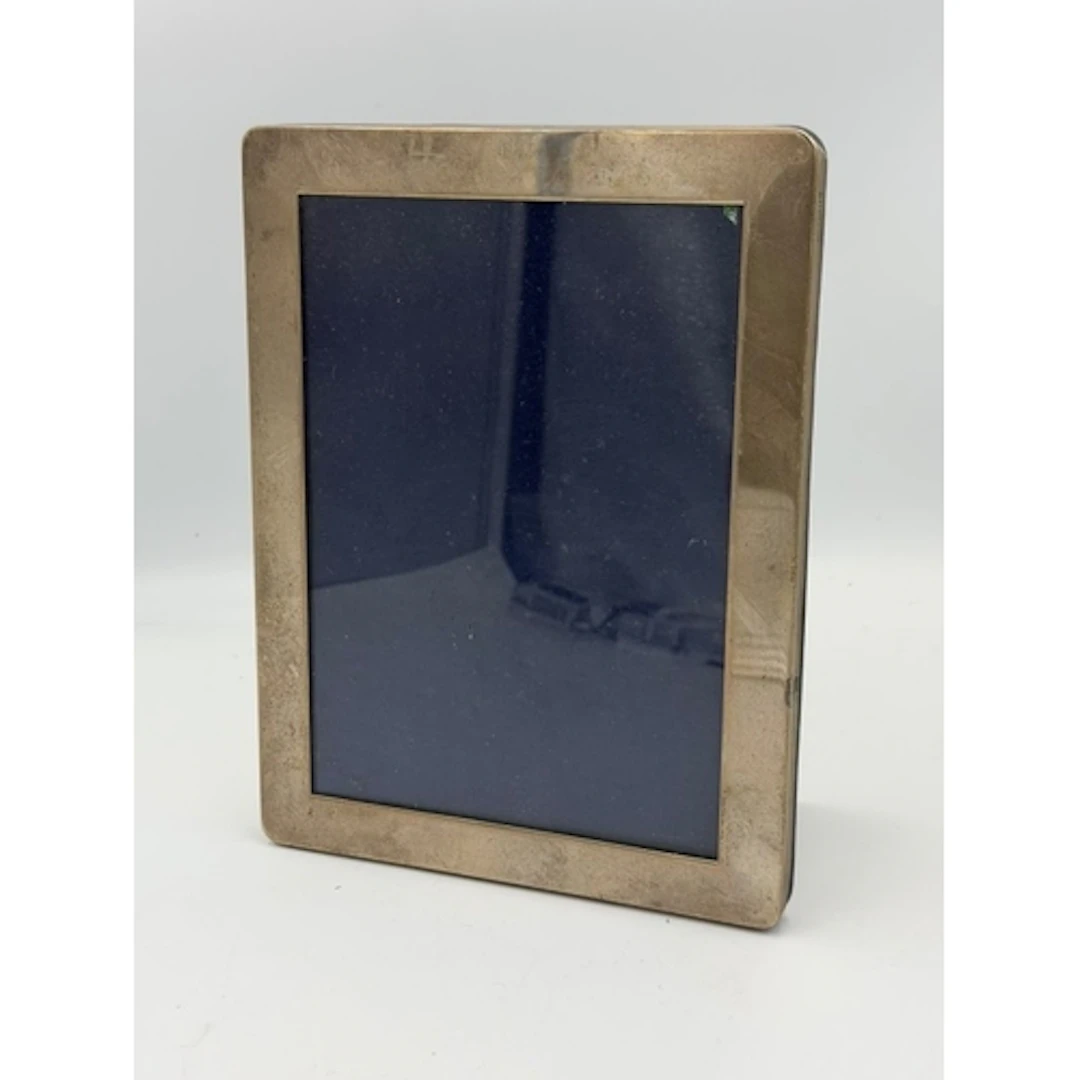A rectangular silver picture frame. easel backed, by Kitney ...