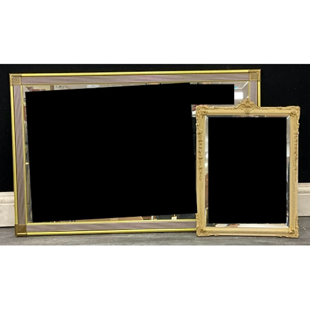 Two mid century framed mirrors, an art deco streamlined mirr...