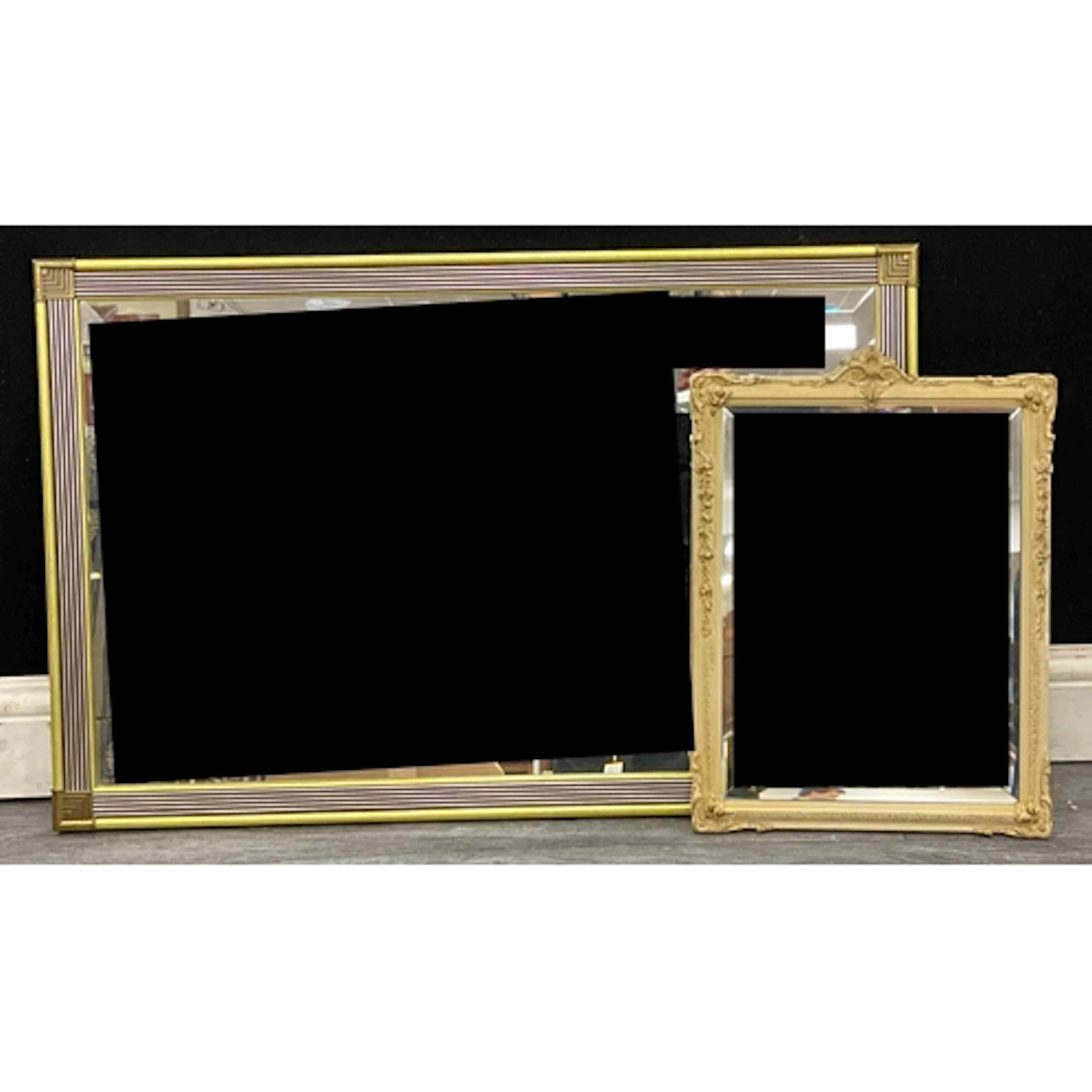 Two mid century framed mirrors, an art deco streamlined mirr...